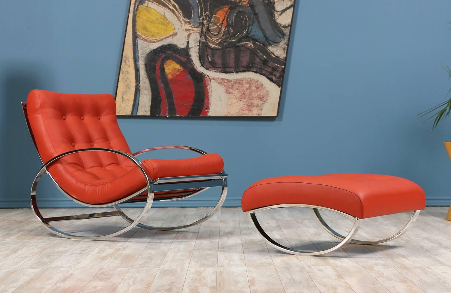 Mid Century Modern rocking chair designed by Renato Zevi for Selig and manufactured in the United States circa 1970’s. This elegant set features elliptical polished chrome frames. Both chair and ottoman cushions have been reupholstered with a new