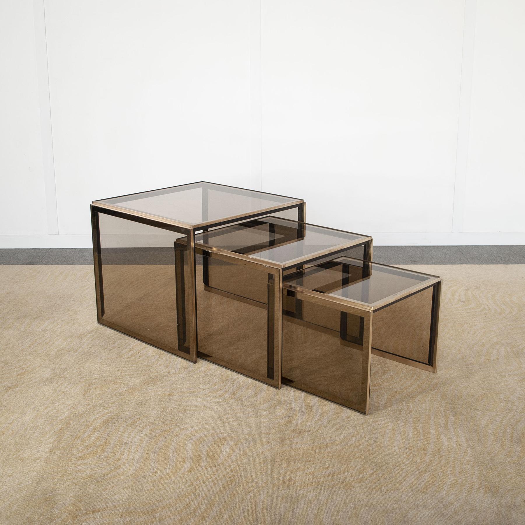 Tris of so called nesting tables designer Renato Zevi in brass and smoked glass production late 1970s.