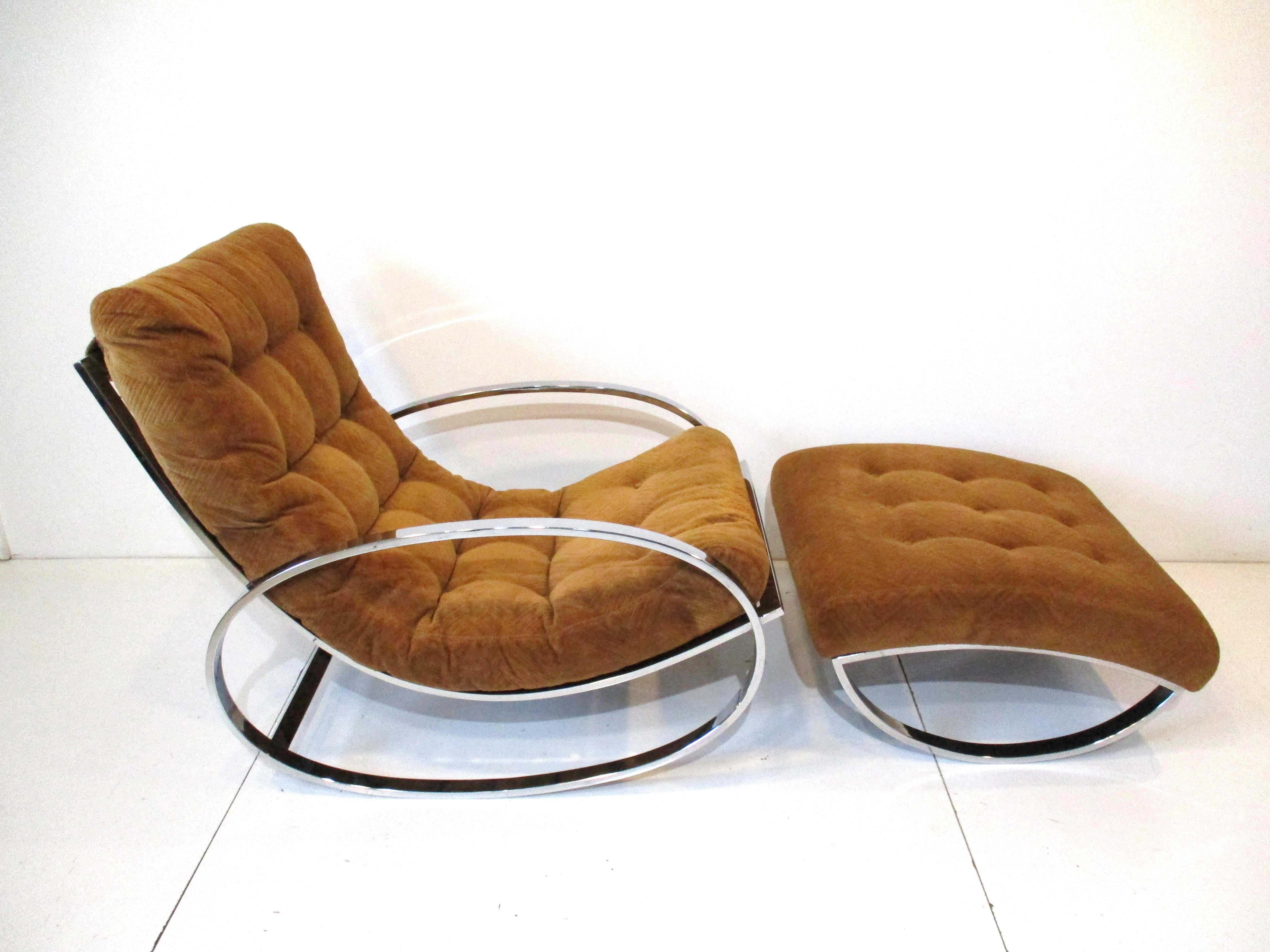 Ellipse lounge chair rocker with sculptural chromed steel flat bar frame and matching ottoman . Retains the original fabric from the period in a medium toned rust having angled patterns and buttons to the seat and ottoman . Designed by Renato Zevi