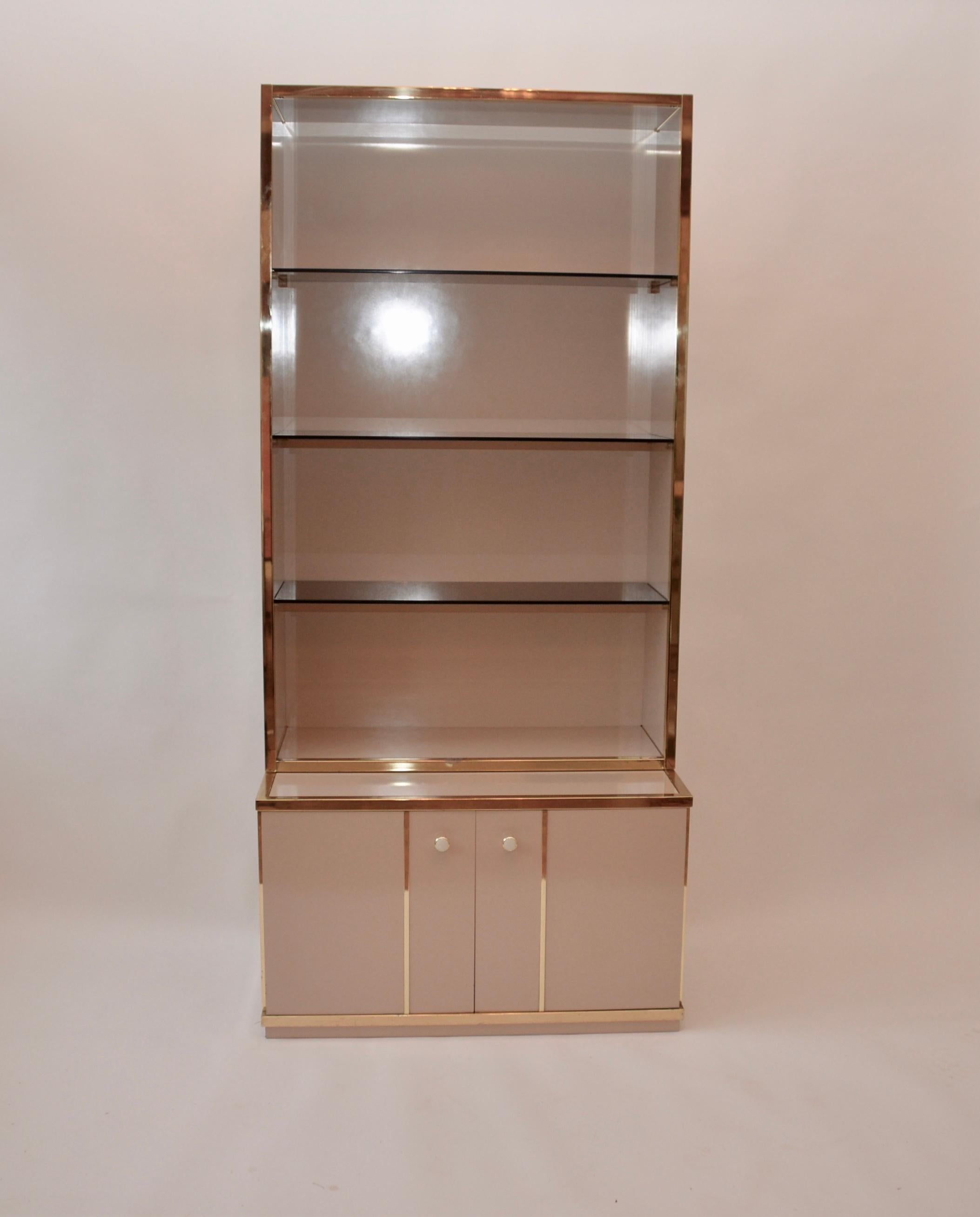 A Renato Zevi for Romeo Rega étagère. A fabulous iconic 1970s item with three tinted glass shelves and
A two-door base unit. A genuine vintage item with a Zevi label inside the cupboard.
