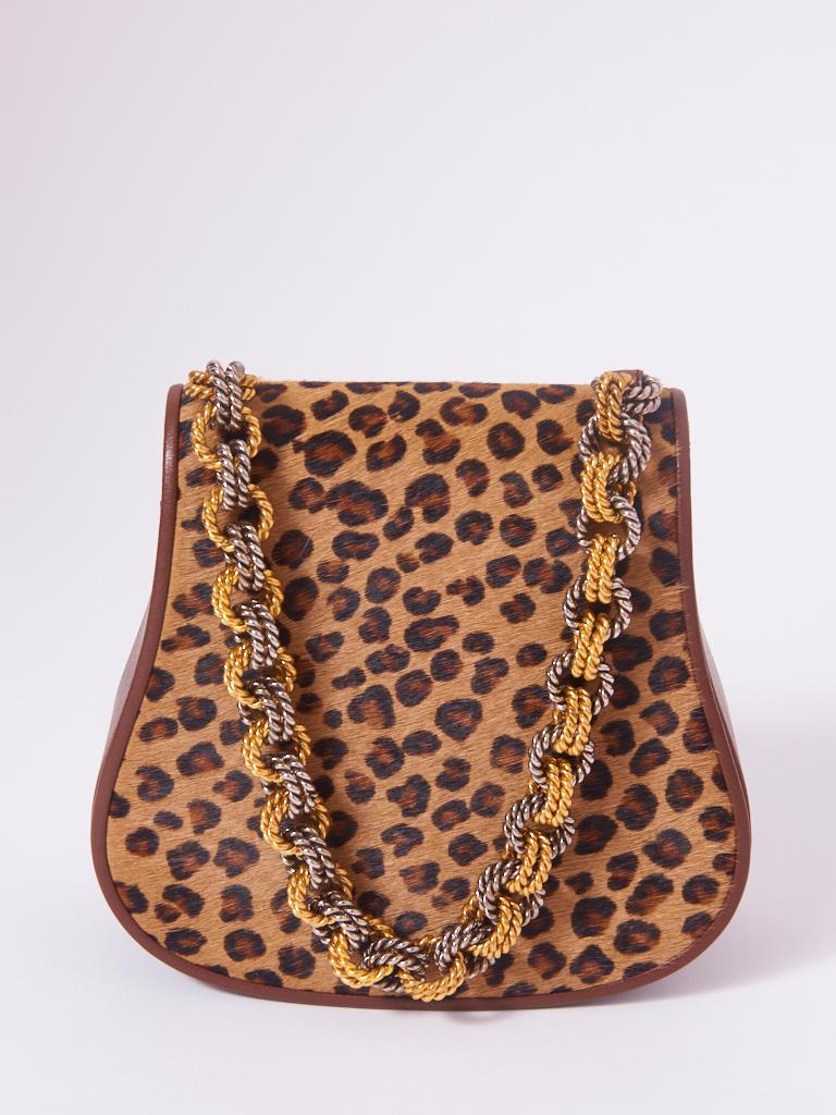 Renaud Pellegrino, leopard pattern, stenciled, calf hair, hard, handbag, having leather sides and a twisted, link chain, handle in gold and silver tone base metal. Faille interior with a zippered compartment.