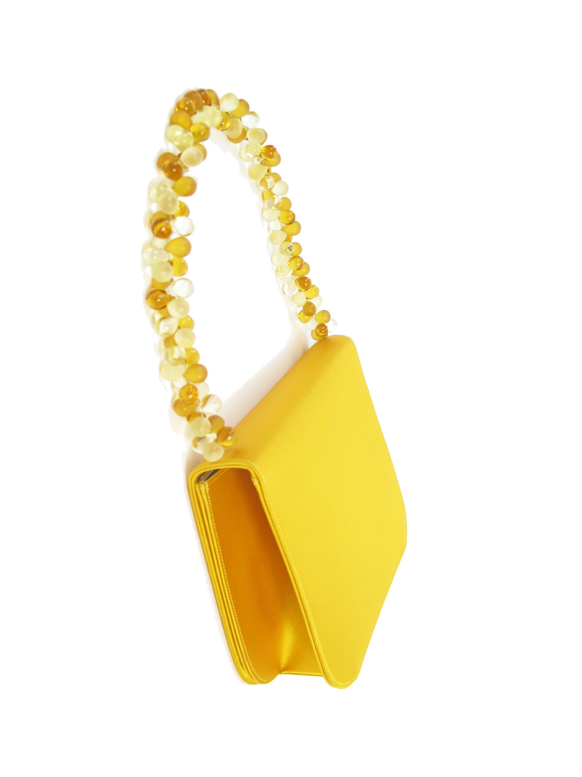 Renaud Pellegrino yellow satin flap bag with beaded handle. Condition: Very good. 
8