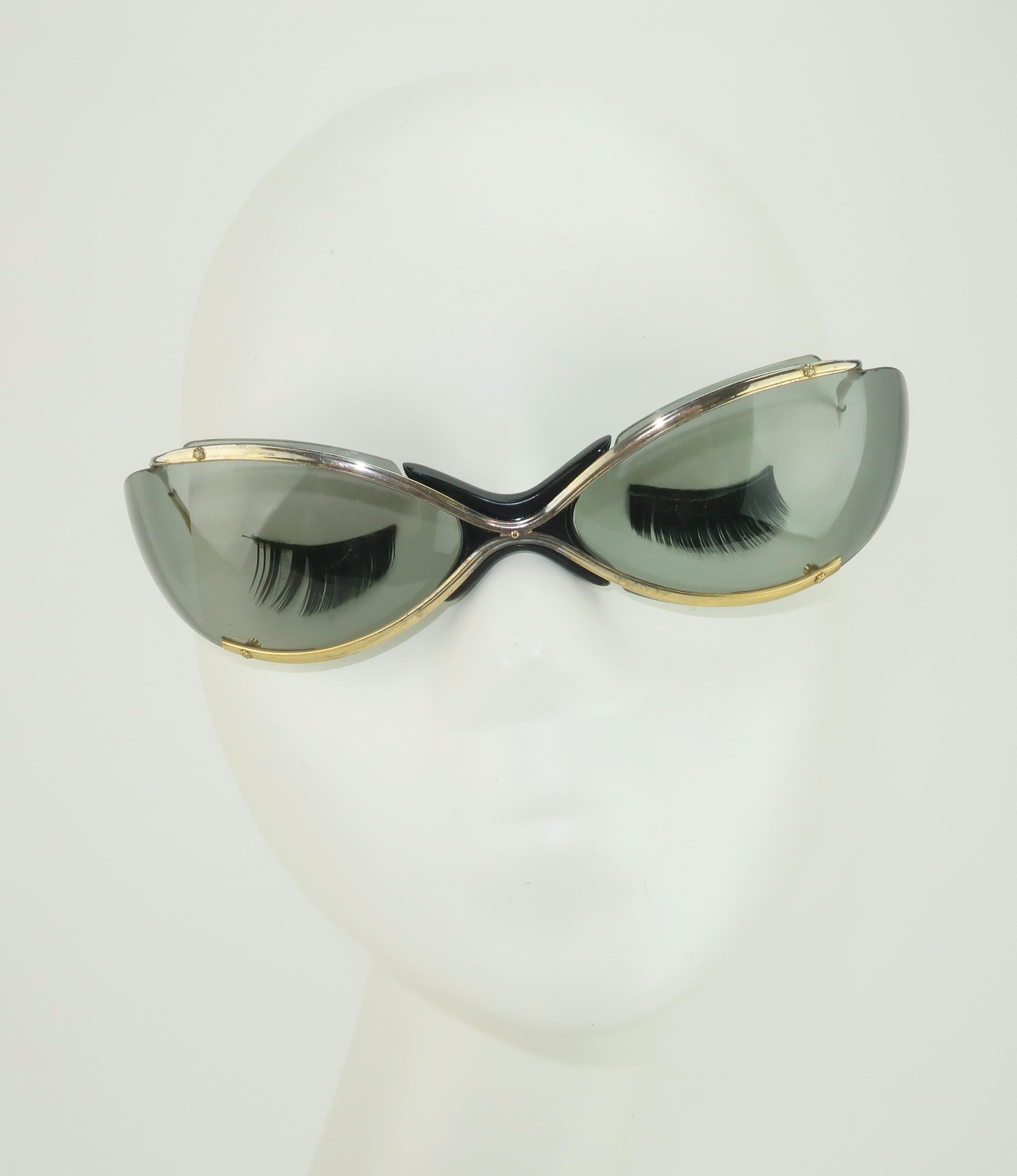 This design may be de rigueur in contemporary eye wear but in the 1960's Renauld of France made a splash with sporty wrap around sunglasses.  Popular among sports enthusiasts including skiers and race car drivers, the space age shape proved both