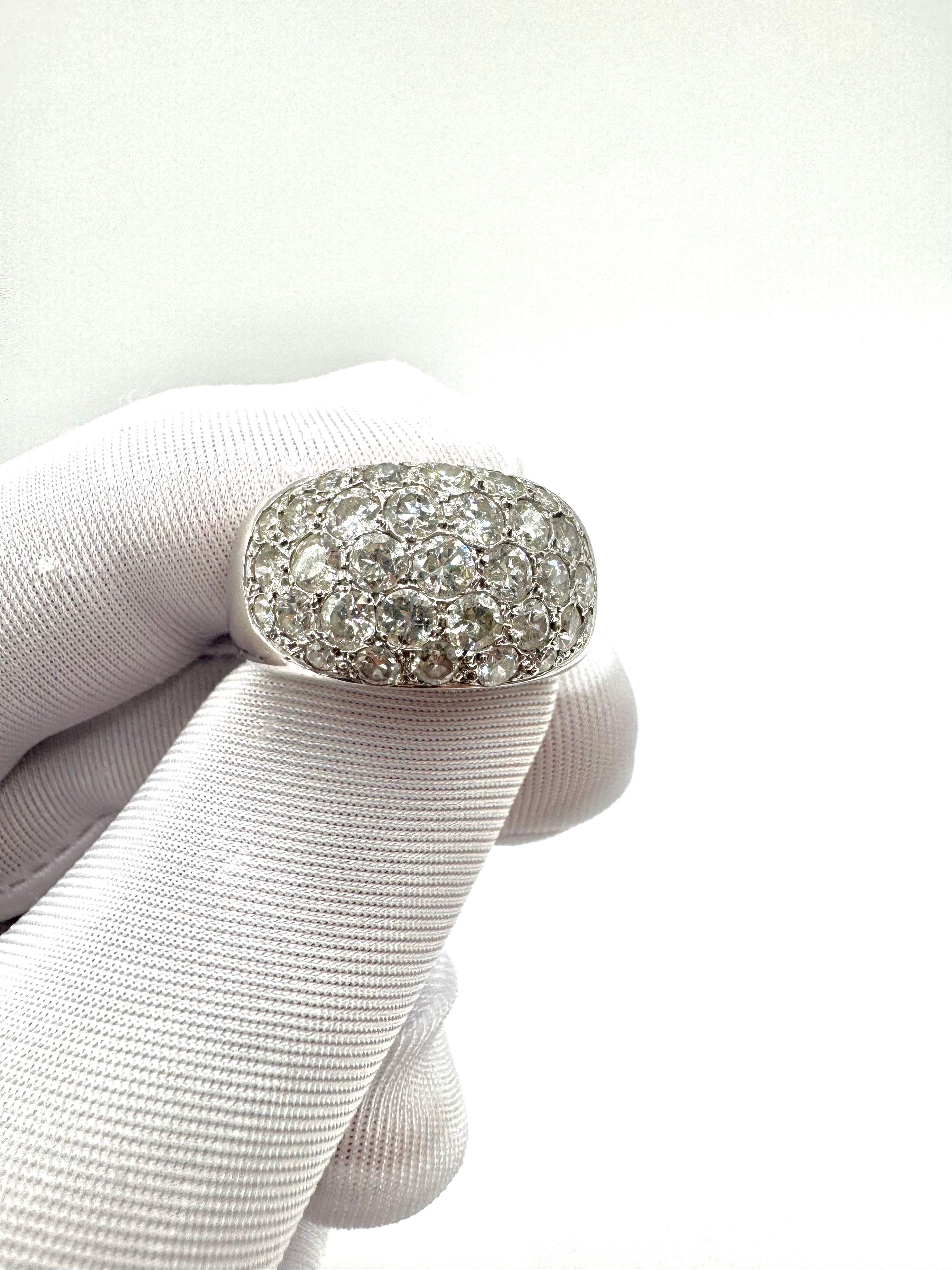 A masterful expression of French vintage glamour, this René Boivin bombe ring is crafted in luxurious platinum and fully pavé-set with a dazzling spread of old European cut diamonds. The dome-shaped surface is encrusted with closely set stones of