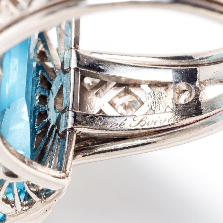 The elegance of linear geometry is a hallmark of classic Art Deco design. This exceptional example by René Boivin features a well saturated step-cut aquamarine accented by pierced scrolling shoulders set with single-cut diamonds mounted in platinum.