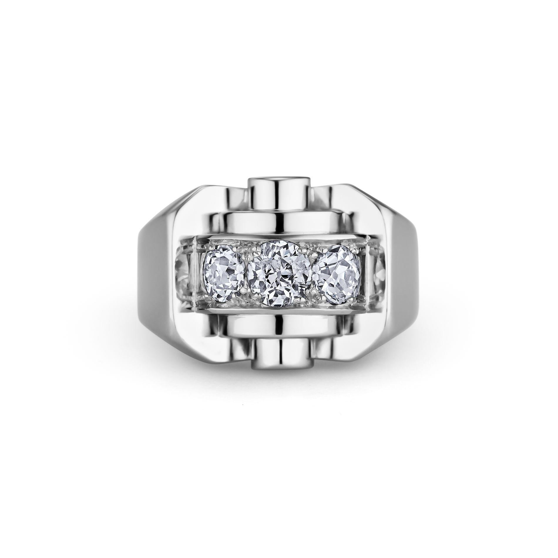 With bold Art Deco architectural elements reminiscent of period skyscrapers, this domed ring attributed to Rene Boivin Paris, is a song in symmetry.  The three round center diamonds, totaling .92 carats, are highlighted by front and back concentric