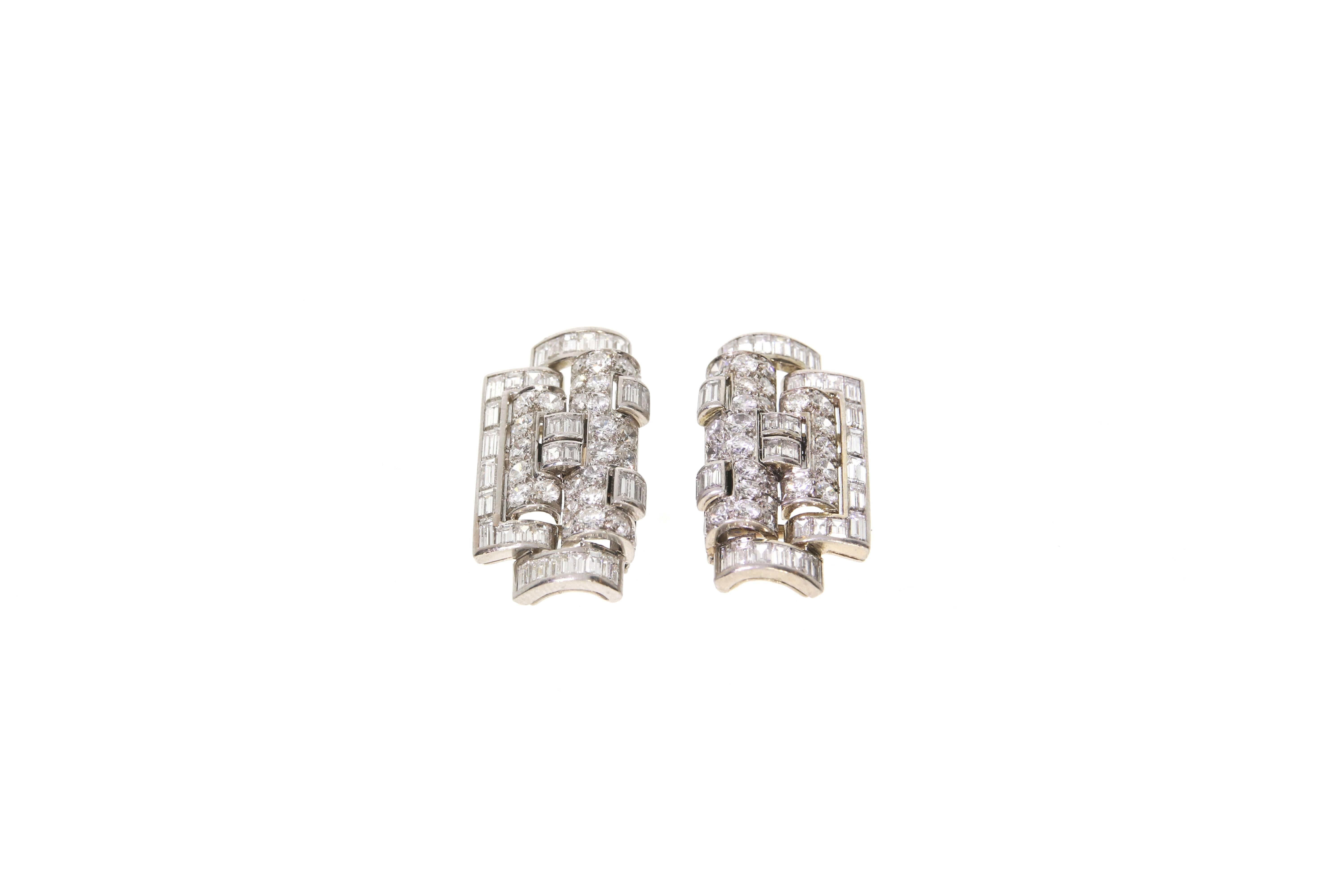 Two exquisite diamond clips, by René Boivin. Each clip is of a geometric design, decorated with 64 baguettes and 54 brilliant cut diamonds (in total approx.: 5,80 ct). Platinum setting and 18 Karats white gold clasp. 
French assay