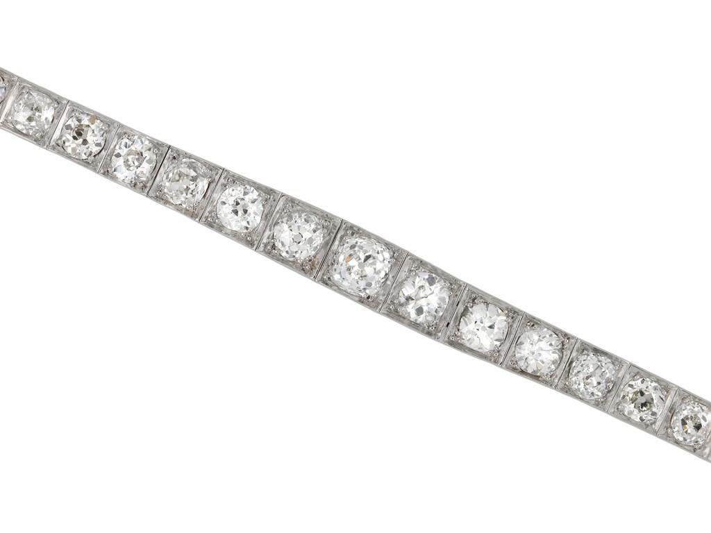 Rene Boivin diamond line bracelet. Set with thirty cushion shape old mine diamonds in open back grain settings with a combined approximate weight of 9.75 carats, to an impressive graduating design featuring square collets, a linear pierced gallery
