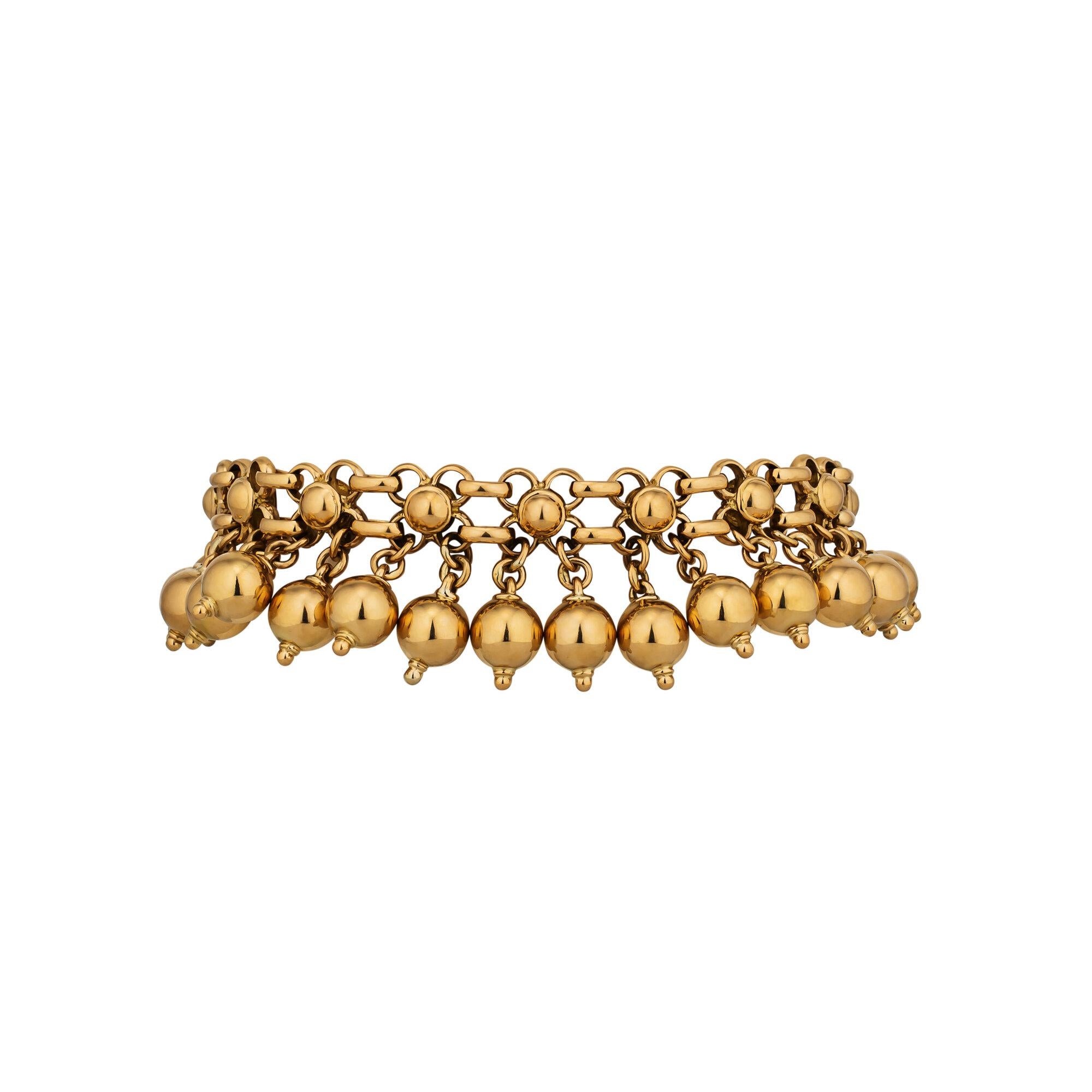 Stir things up with this vintage French Rene Boivin beaded fringe bracelet.  With 32 gold beads gracefully dancing from a mesh link bracelet, this circa 1980 collectible jewel will liven up your wardrobe.  Signed Boivin.  18 karat yellow gold.  7