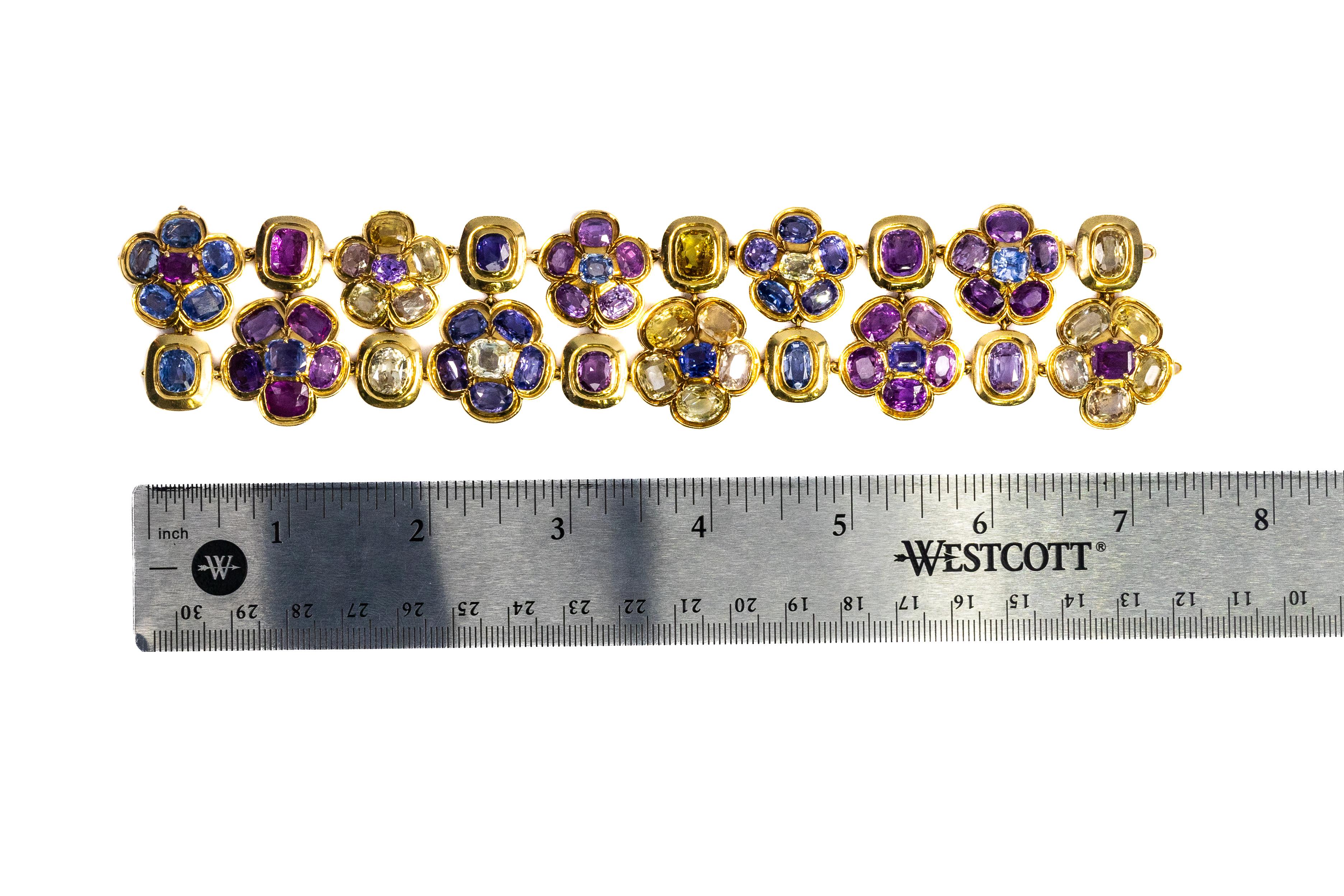 Discover the enchanting beauty of this René Boivin Sapphire Bracelet, a stunning piece that embodies the designer's exquisite craftsmanship and floral artistry. This bracelet features a captivating arrangement of 70 cushion and oval-shaped sapphires