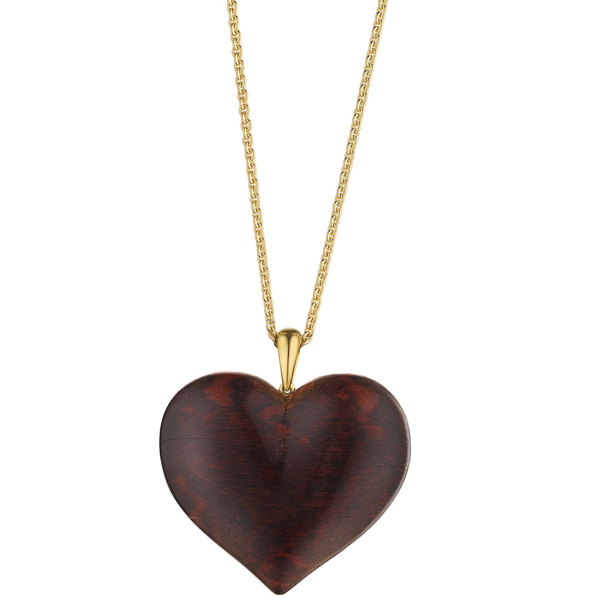 Heart felt.  This vintage Rene Boivin Paris natural wood and gold bombe heart pendant is filled with timeless emotion.  Enhanced with polished 18 karat yellow gold bead and trefoil motifs, this romantic pendant heart is both rare and collectible. 