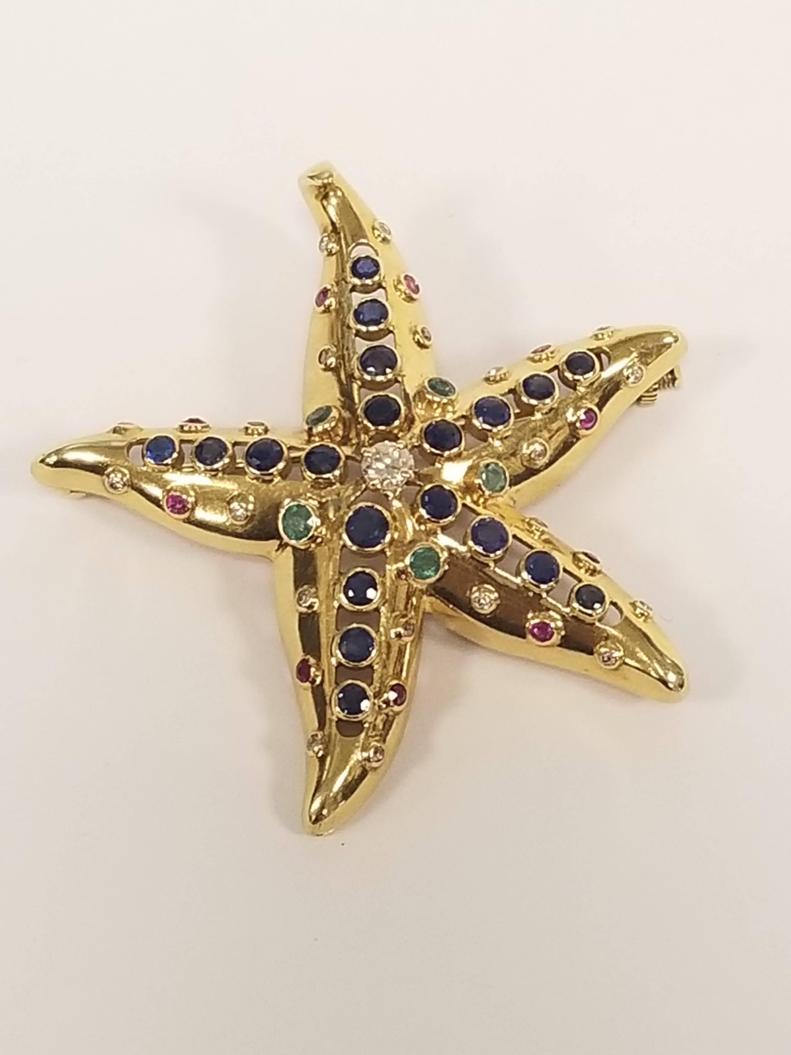 A French 18 karat gold starfish brooch with sapphire, diamond, emerald and ruby by René Boivin. The brooch has 20 sapphires with an approximate total weight of 1.55 carats, 21 diamonds with an approximate total weight of .65 carat, 5 emeralds with