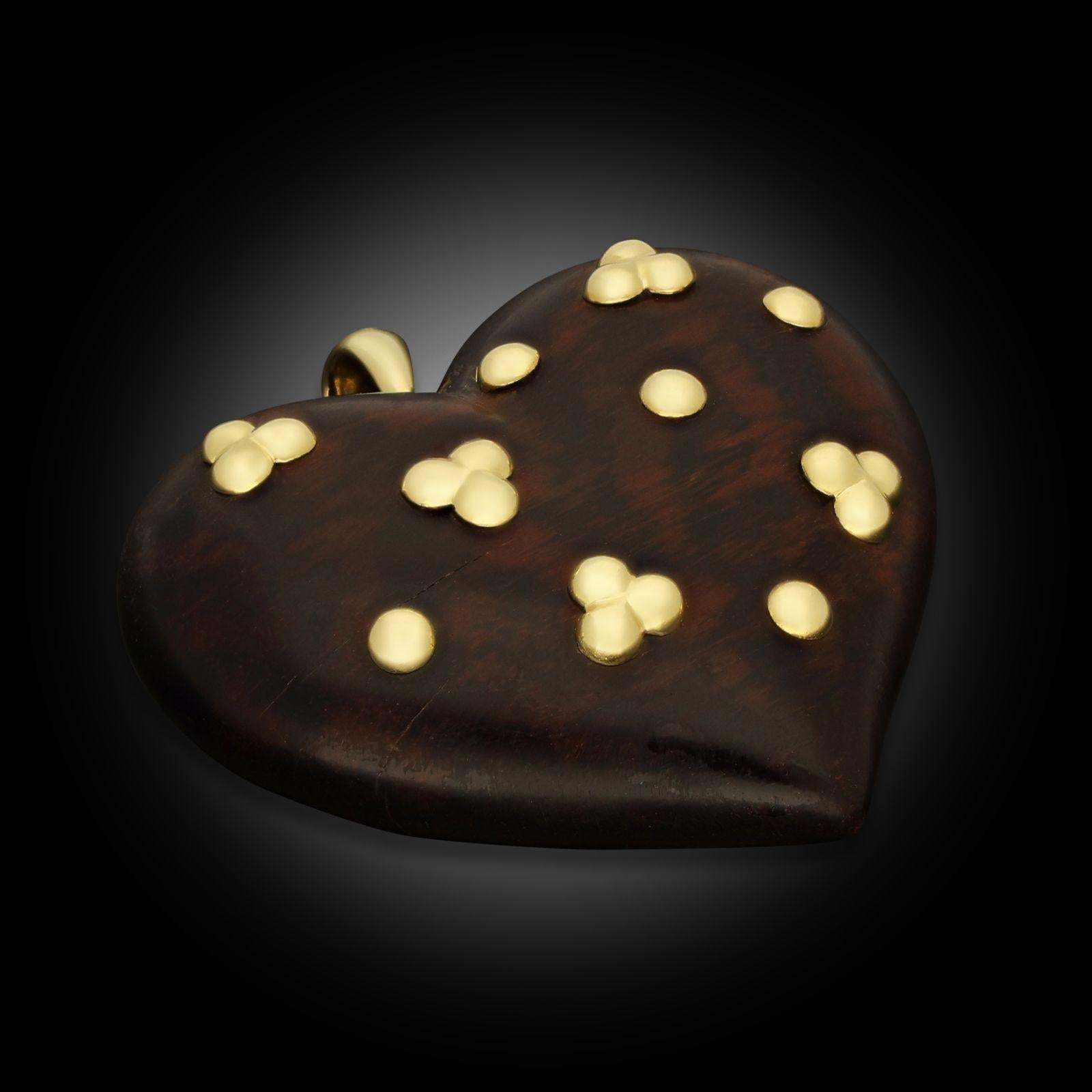 A vintage wood and yellow gold pendant by René Boivin, circa 1970. The pendant is designed as a large bombé heart made from snakewood with polished 18ct yellow gold beads and suspended from a 18ct yellow gold bale.
Maker
René Boivin
Period
circa
