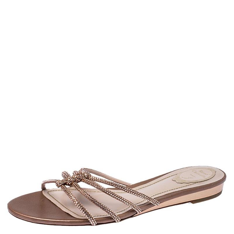 Firmly committed to creating elegant designs for women, this pair from Rene Caovilla is made in beige. Exuding feminine charm, this pair is characterised by an ornate vamp. The slip-on style and flat design make them easy to wear.

Includes: