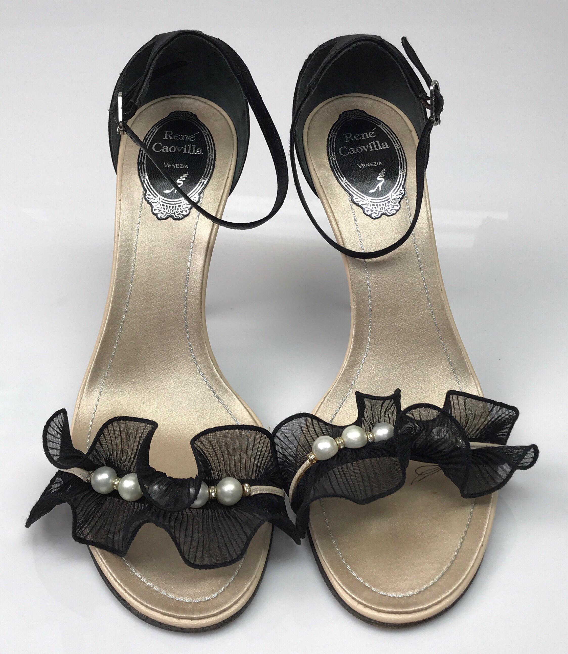 Rene Caovilla black heel w/ ruffle & pearl detail on toe strap-39. These elegant Rene Caovilla heels are in great condition. They show minor signs of wear, including the bottom of the shoe where some of the sparkles are rubbed off. The shoe is made