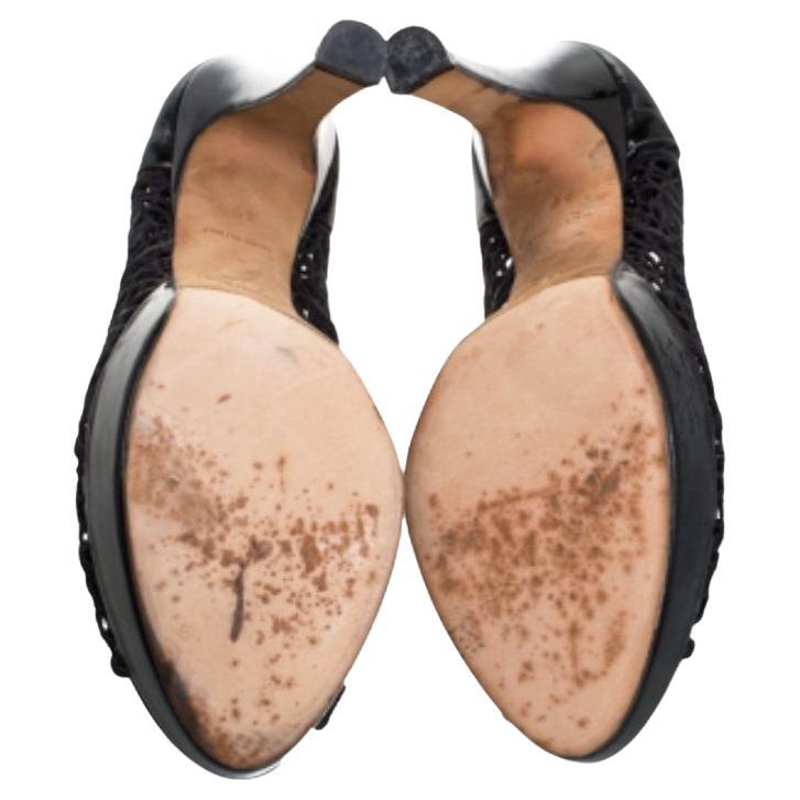 These stunning pumps by René Caovilla are the epitome of sophistication. Crafted in Italy, they are made from intricate lace and patent leather. They come in a classic shade of black and will complement a hot of outfits. They are styled with peep