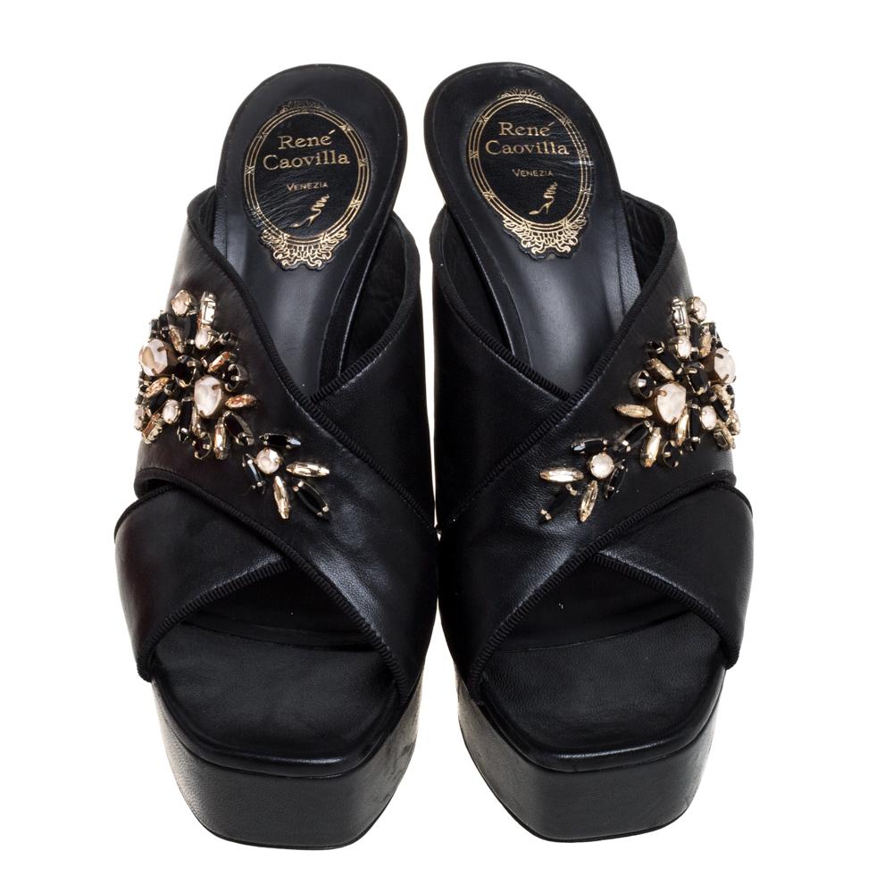Designed with squared peep toes and beautiful crystal embellishments on the crisscross straps, these René Caovilla mules are simply divine! They've been beautifully crafted from leather in a mesmerizing black hue. They are styled with leather-lined
