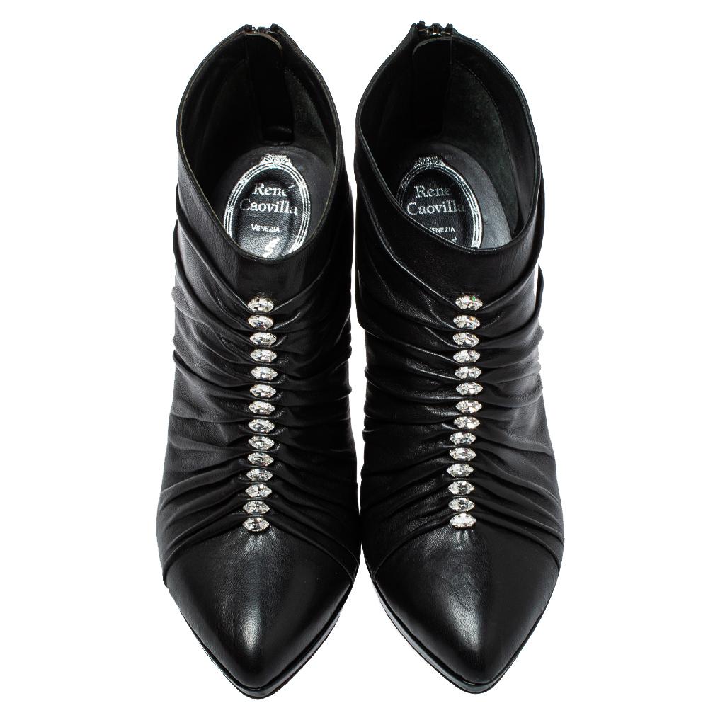 Grab these chic and stylish ankle boots by Rene Caovilla. They have been crafted in Italy and made from black leather. They have pleat detailing, crystal embellishments, pointed toes, platforms, 11.5 cm heels ad zip closures at the back.

Includes: