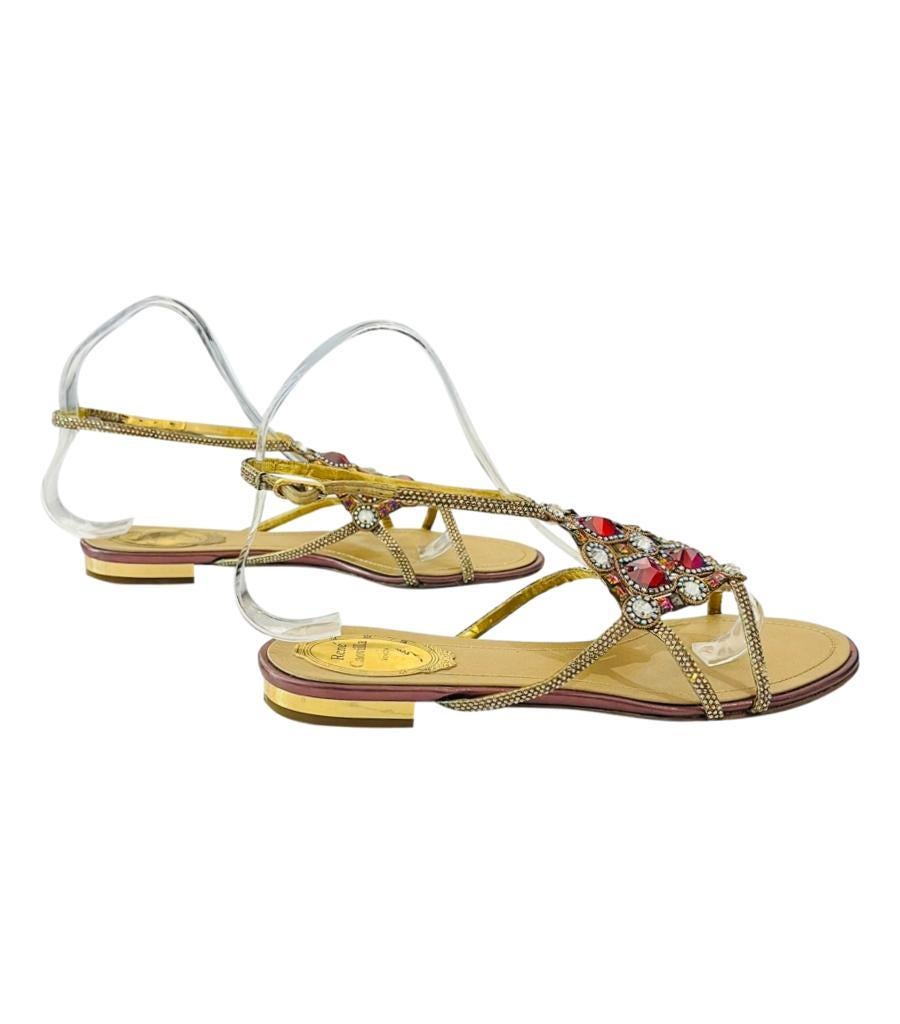 Rene Caovilla Crystal Embellished Leather Sandals

Gold sandals detailed with oversized crystal design in red and silver to the vamp.

Featuring crystal lined leather stripes with ankle buckled fastening.

Size – 38.5

Condition – Good (General