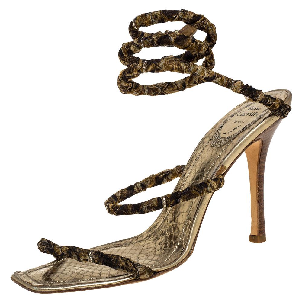 Breathtakingly beautiful, these Cleo sandals from Rene Caovilla are sure to delight you with their style and design! Glamorous in gold, they have been crafted from leather and fabric and styled with coiled straps that resemble a serpent, meant to