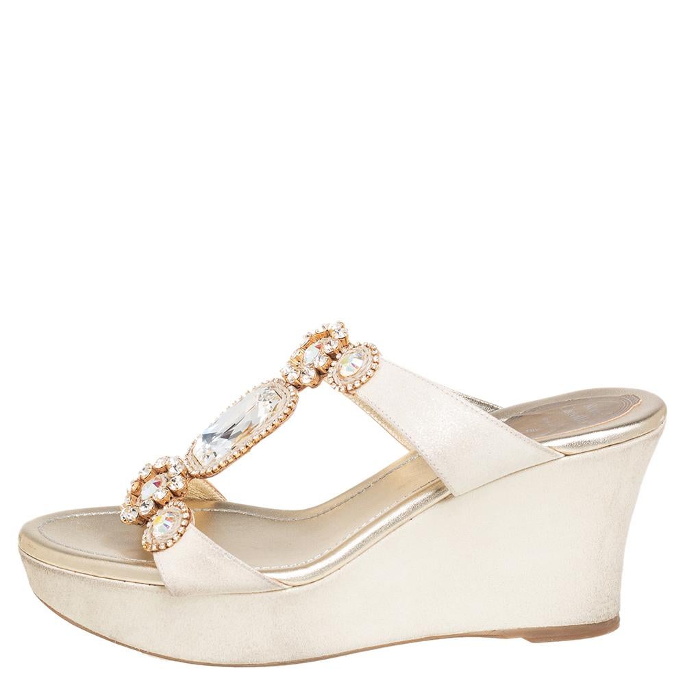 These lovely Rene Caovilla sandals will bring the right amount of style and shine to your feet. They are crafted from gold glitter nubuck and feature exquisite crystal-embellished straps on the vamps and 8 cm platform wedge heels. They are pretty