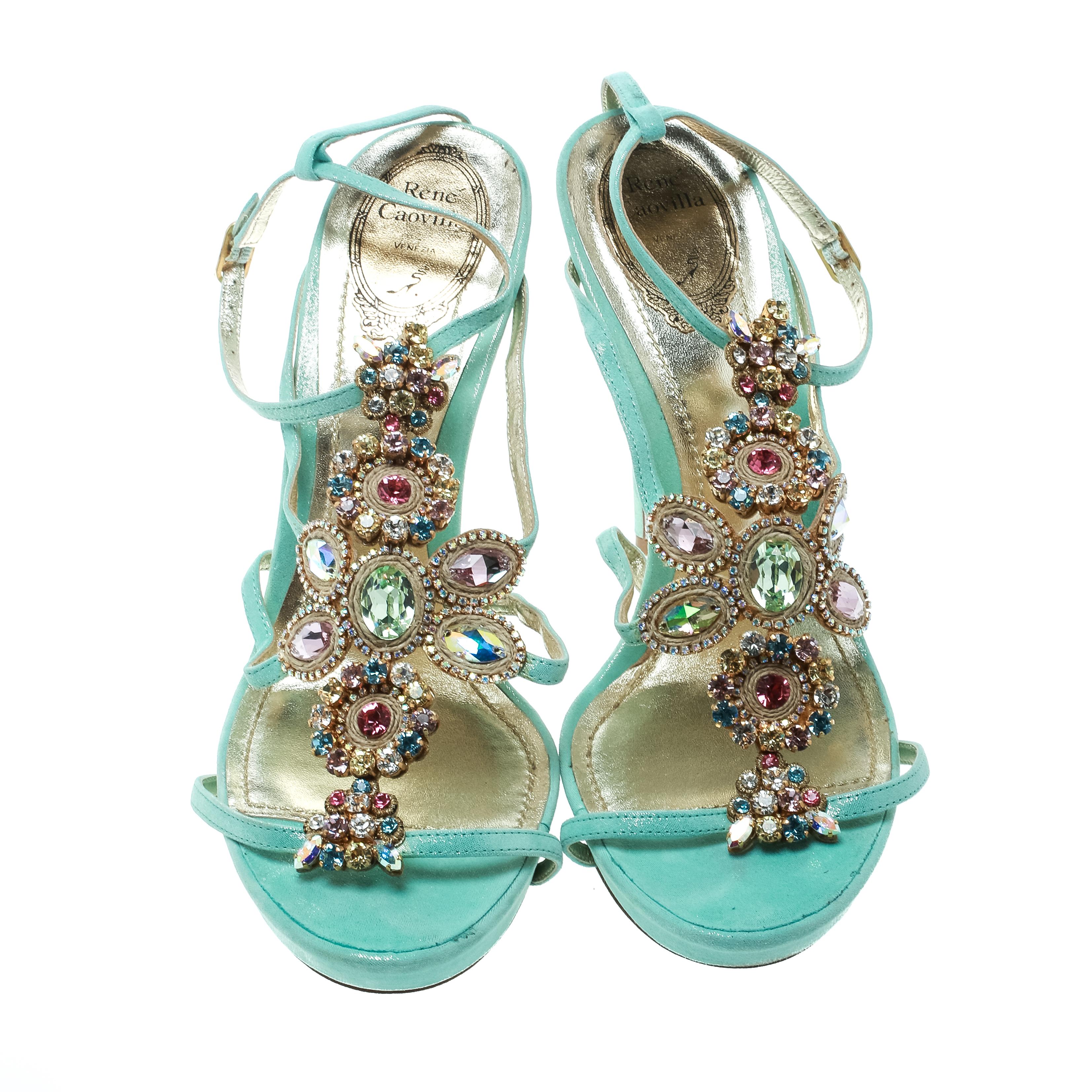 You'll love to make others go gaga in these exquisite sandals from Rene Caovilla! The fabulous mint blue sandals are crafted from suede and feature stunning crystal embellishments on the vamps. They flaunt leather lined insoles, 13 cm stiletto