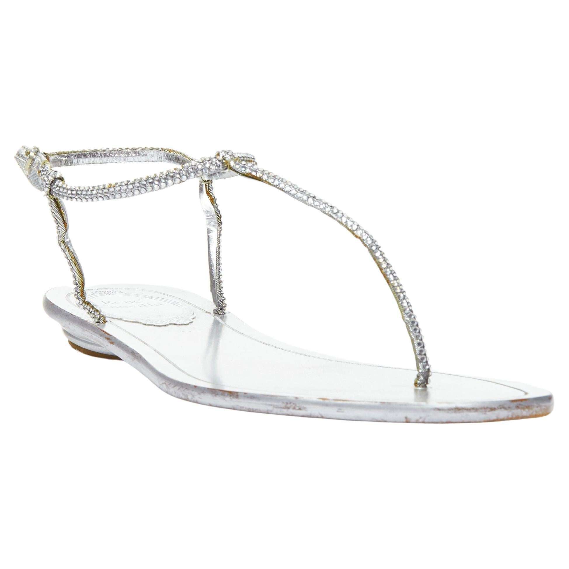 RENE CAOVILLA silver strass rhinestone T-strap flat thong sandals EU36 
Reference: MELK/A00215 
Brand: Rene Caovilla 
Material: Leather 
Color: Silver 
Pattern: Solid 
Closure: BUckle 
Made in: Italy 

CONDITION: 
Condition: Good, this item was