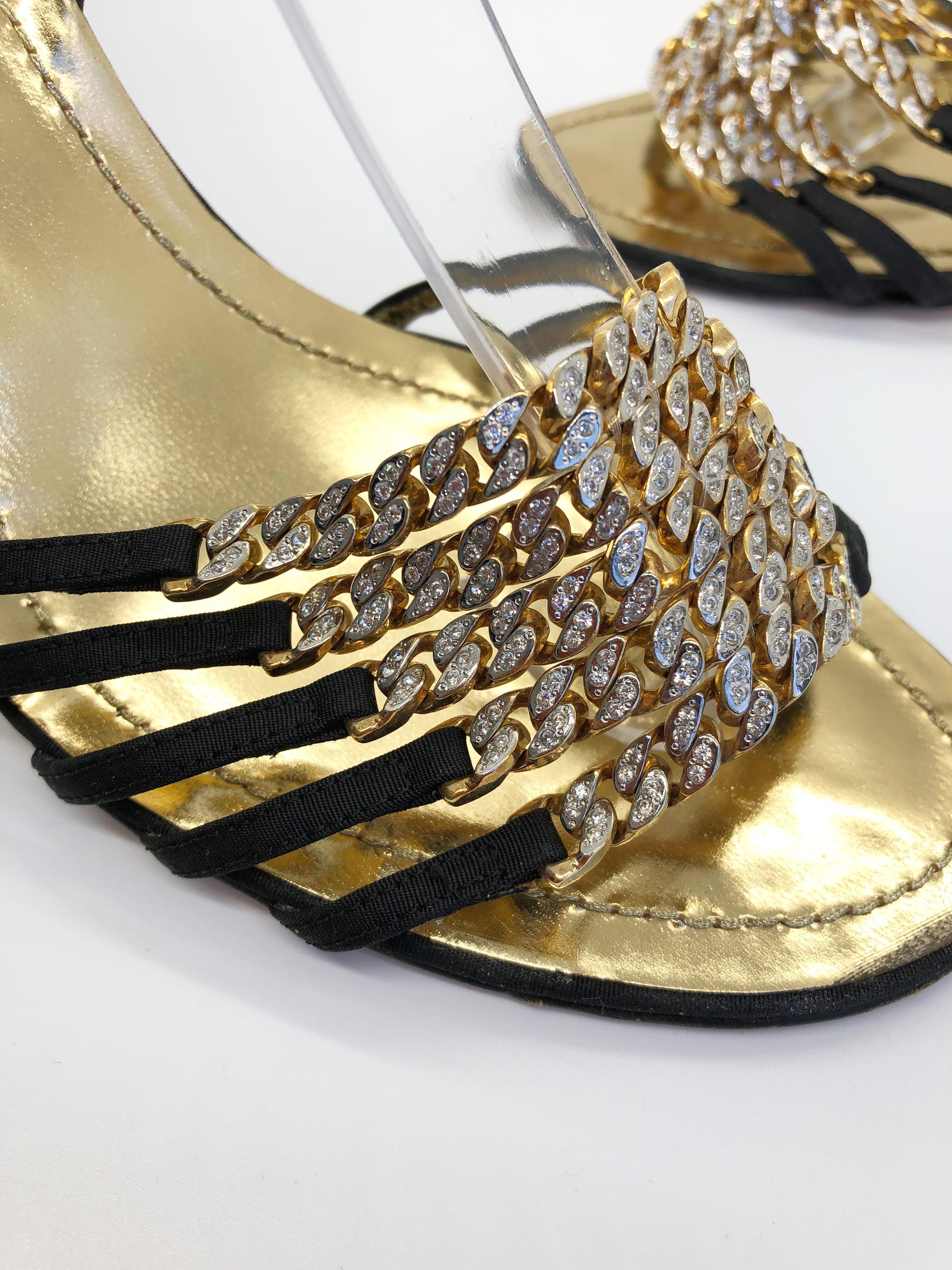Gorgeous RENE CAOVILLA Size 38.5 / US 8.5 black and gold rhinestone strappy high heel sandals ! Features black silk grosgrain straps with gilted gold metal hardware. Thousands of rhinestones on the gold chainlink straps. Adjustable buckle on the