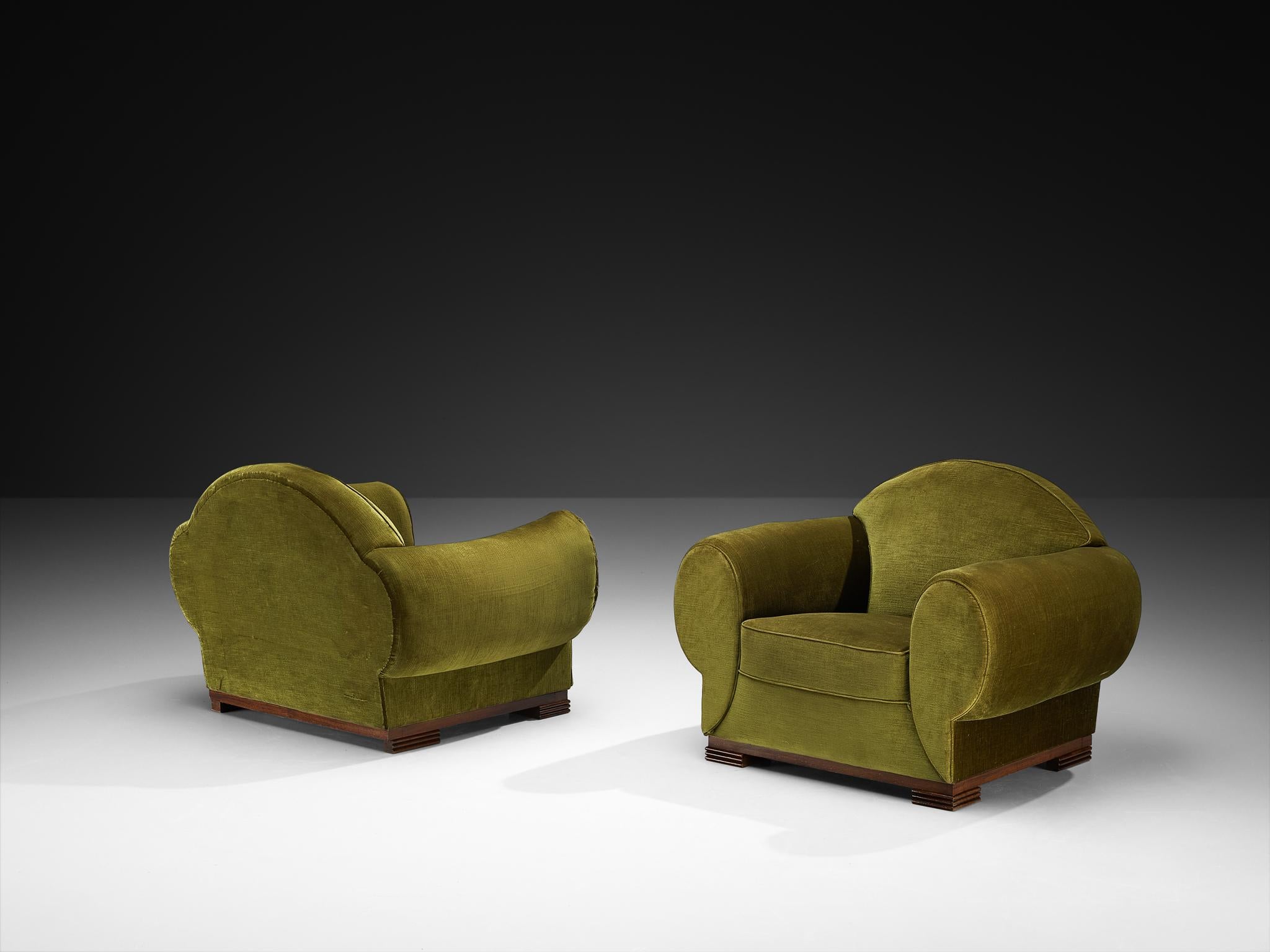 René Drouet, pair of lounge chairs, corduroy velvet, walnut, France, 1930s

Designed by French decorator René Drouet, these club chairs are a quintessential example of French Art Deco, a style that favored assertive geometry and bold, sculptural