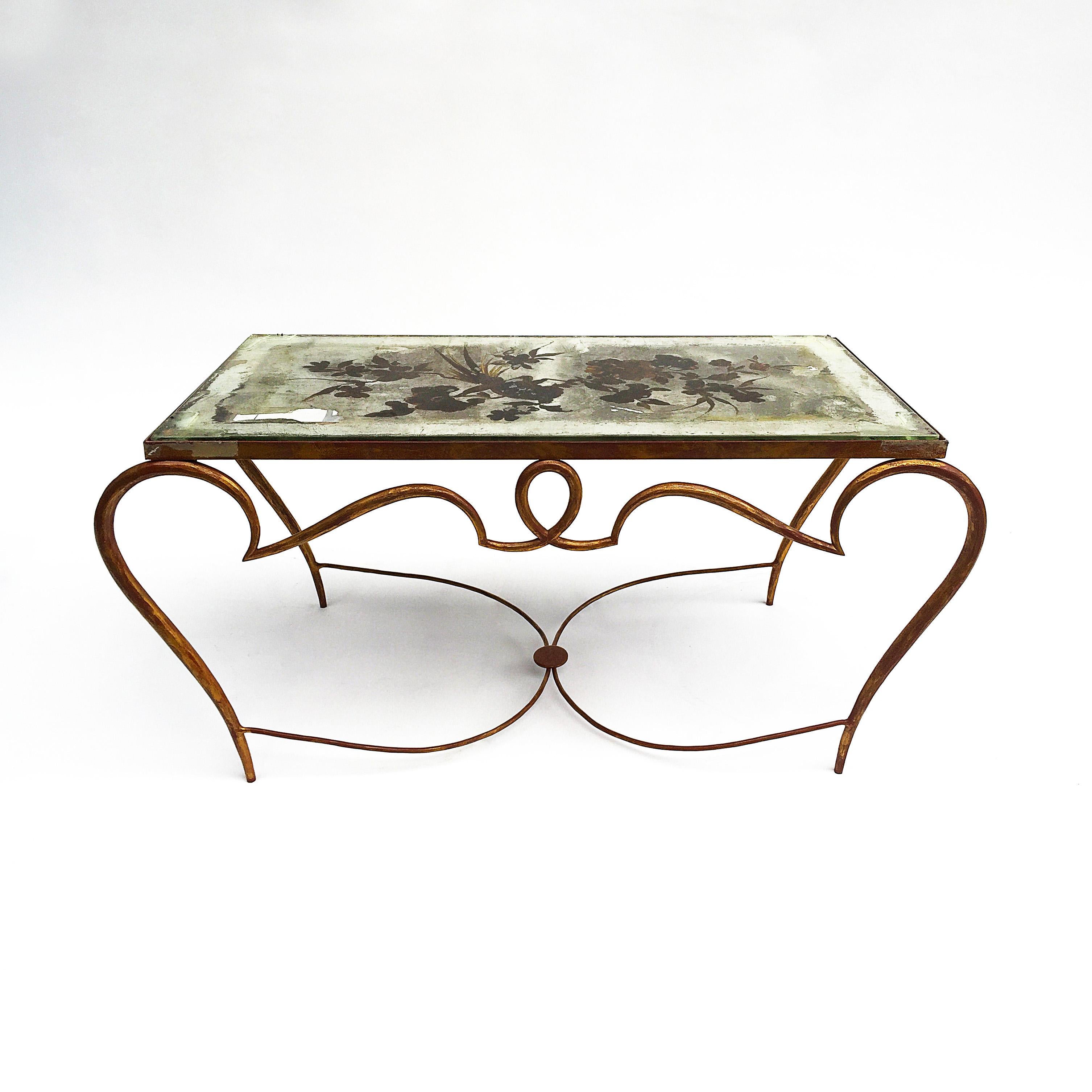 An amazing and historical piece of cocktail table by Rene Drouet that have been documented in several publications.
This French gilt cocktail coffee table by Rene Drouet surprisingly still owns its original églomisé mirrored top created by Pierre