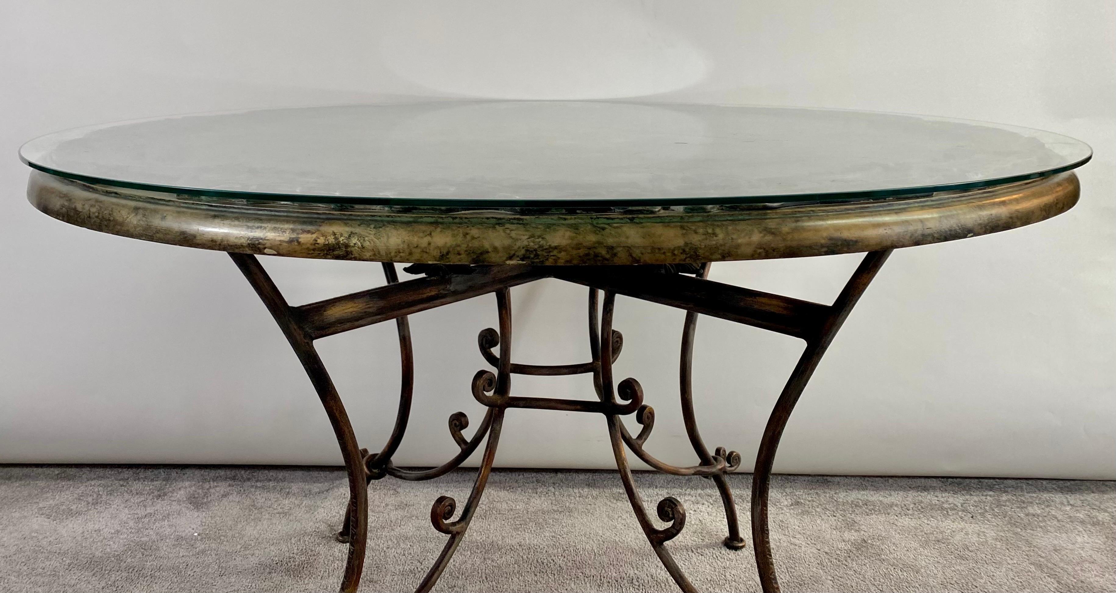 An exquisite French Neoclassical style round center table or dining table in the style of Rene Drouet (French, 1899). The beautiful table top is hand painted featuring floral design and a large flower bouquet on an antiqued tone surface in brown ,
