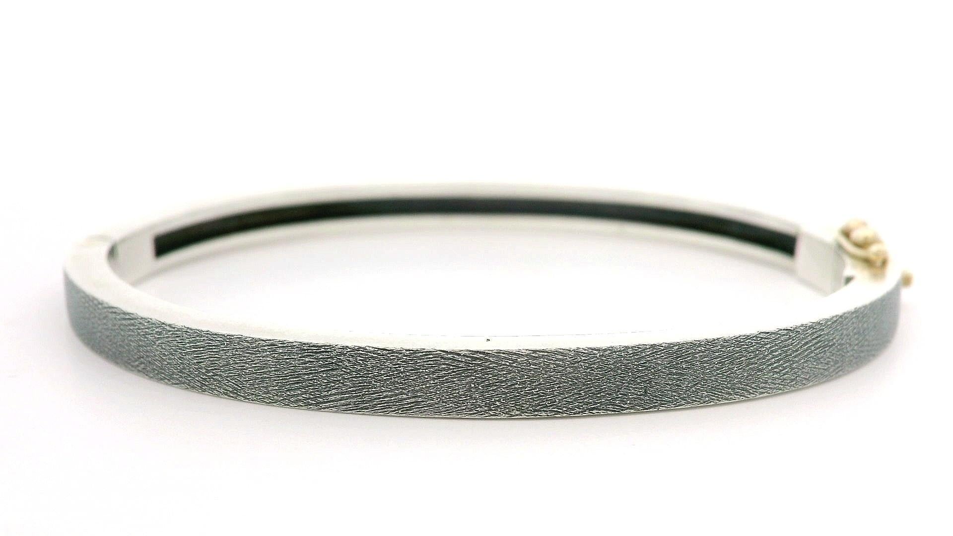 --Stone(s):--
(30) Natural Genuine Diamonds - Round Brilliant Cut - Burnish Set - Nice White Color

Material: Solid Sterling Silver w/ 18k Yellow Gold Accents
Weight: 20.90 Grams
Type: Hinged Bangle
Overall Length: Will Comfortably Fit up to 6.5”