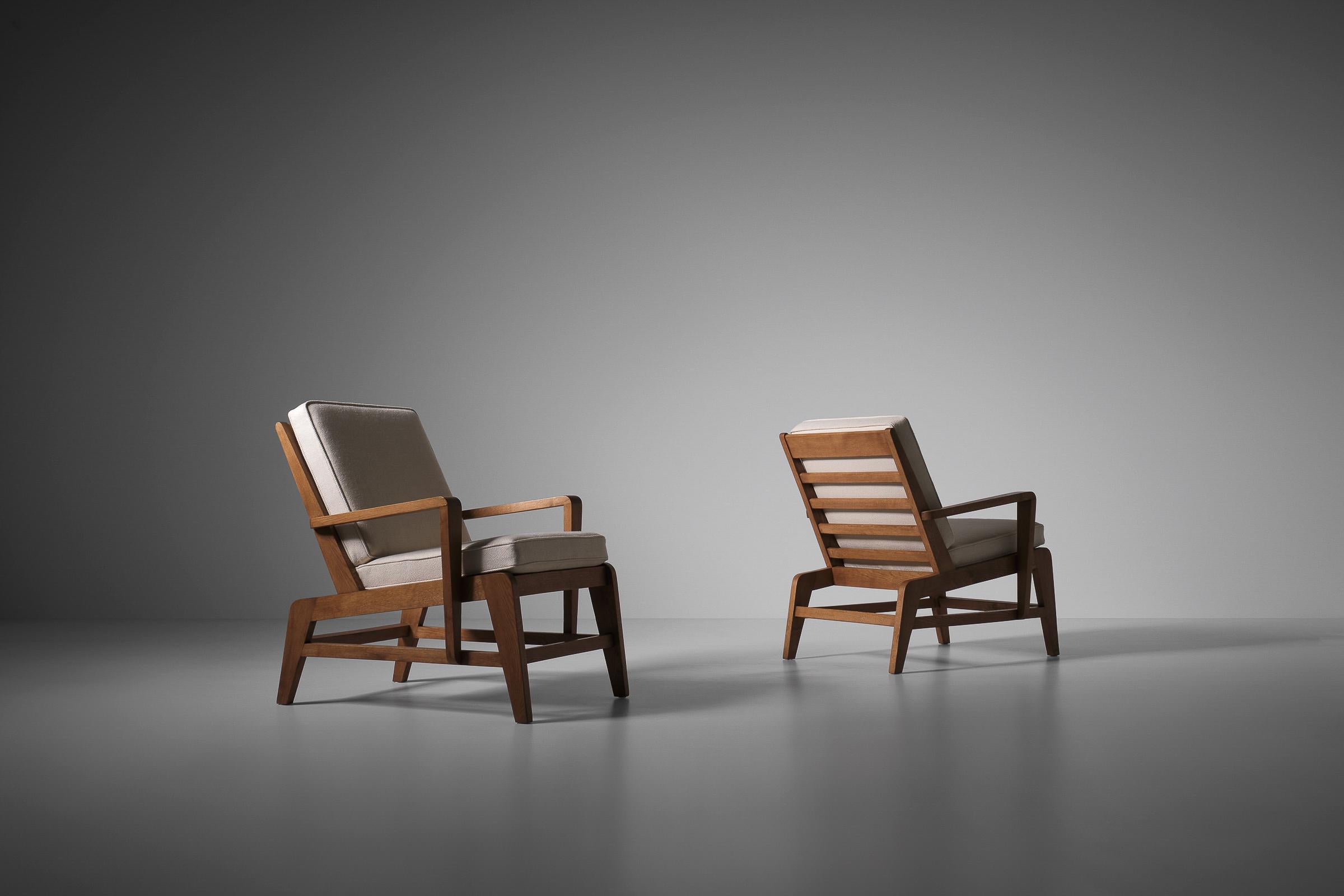 Set of two armchairs in French Oak by René Gabriel (1890 - 1950). Very rare (higher than usual) model with all the typical 'Gabriel' details such as the characteristic sharp angles which come back in every part of the design, the connections and of