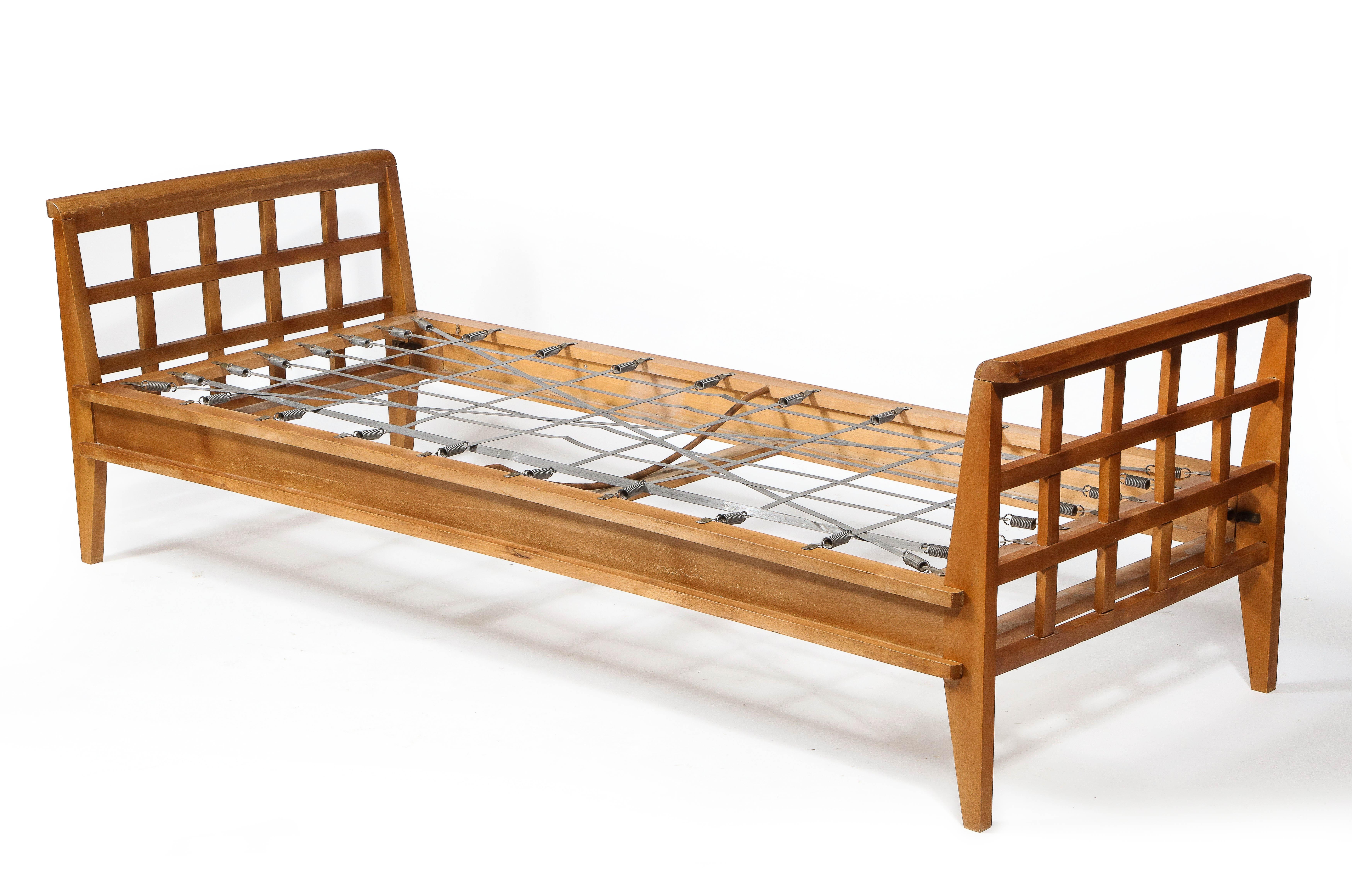 A René Gabriel daybed of the reconstruction period in the original patina, of note, Is the layered construction of the lower frame that gives the daybed a strong presence—refinishing and upholstery in COM are available.