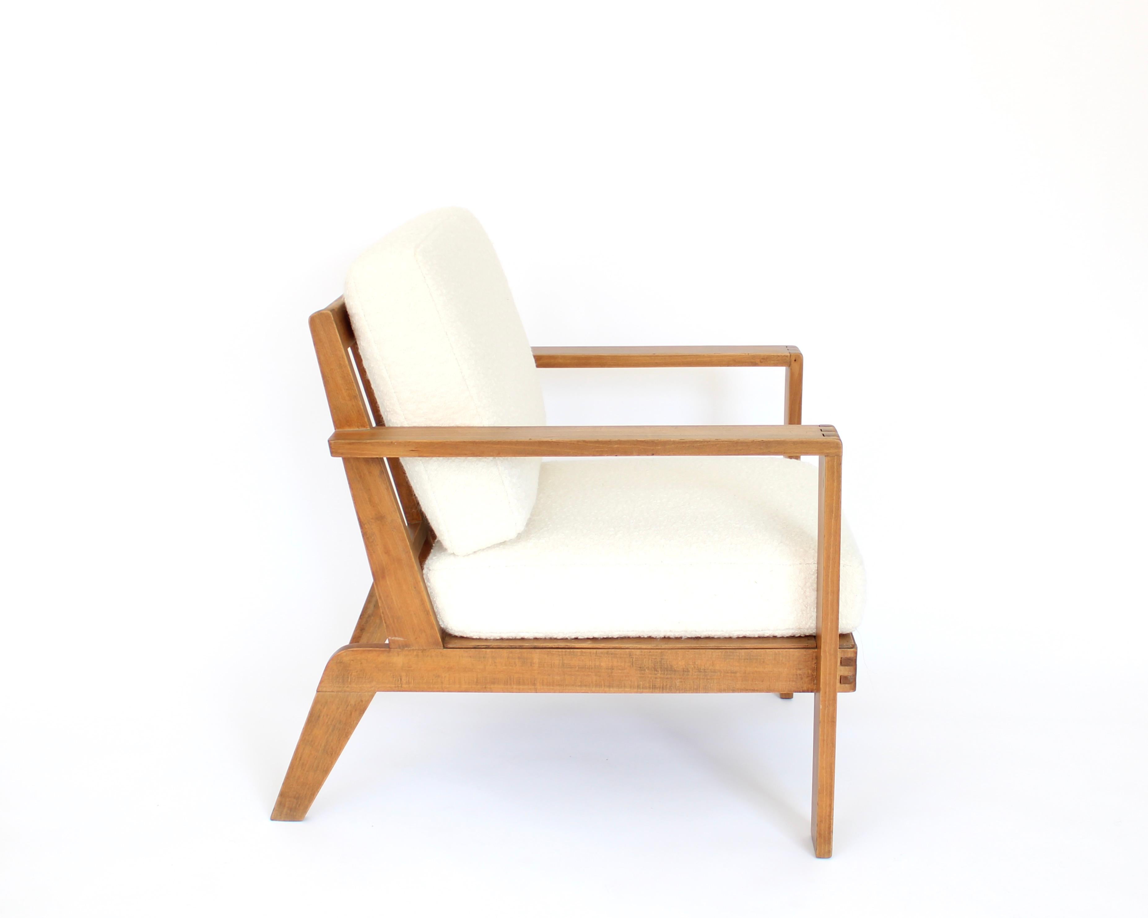 The iconic French oak wood lounge chair and armchair by French designer Rene Gabriel with grid back. 
Newly upholstered and new cushions done in a cream white Italian boucle.
Rene Gabriel designed many pieces during the post war period or in