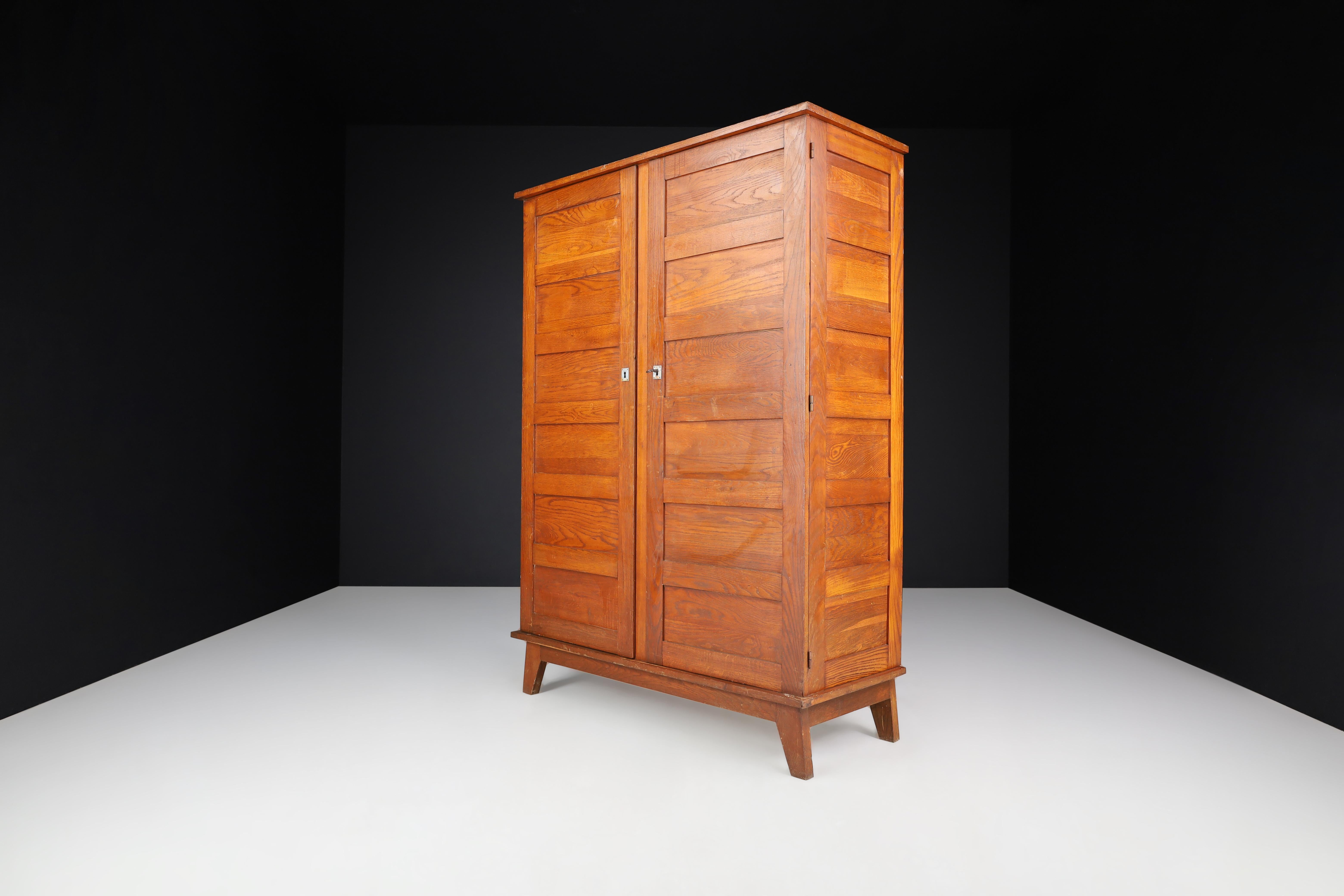 René Gabriel Patinated Oak Armoire France, 1940

This French oak armoire was designed by René Gabriel in the 1940s as part of a collection of emergency furniture created to furnish interiors after the war. It has acquired a lovely patina over time