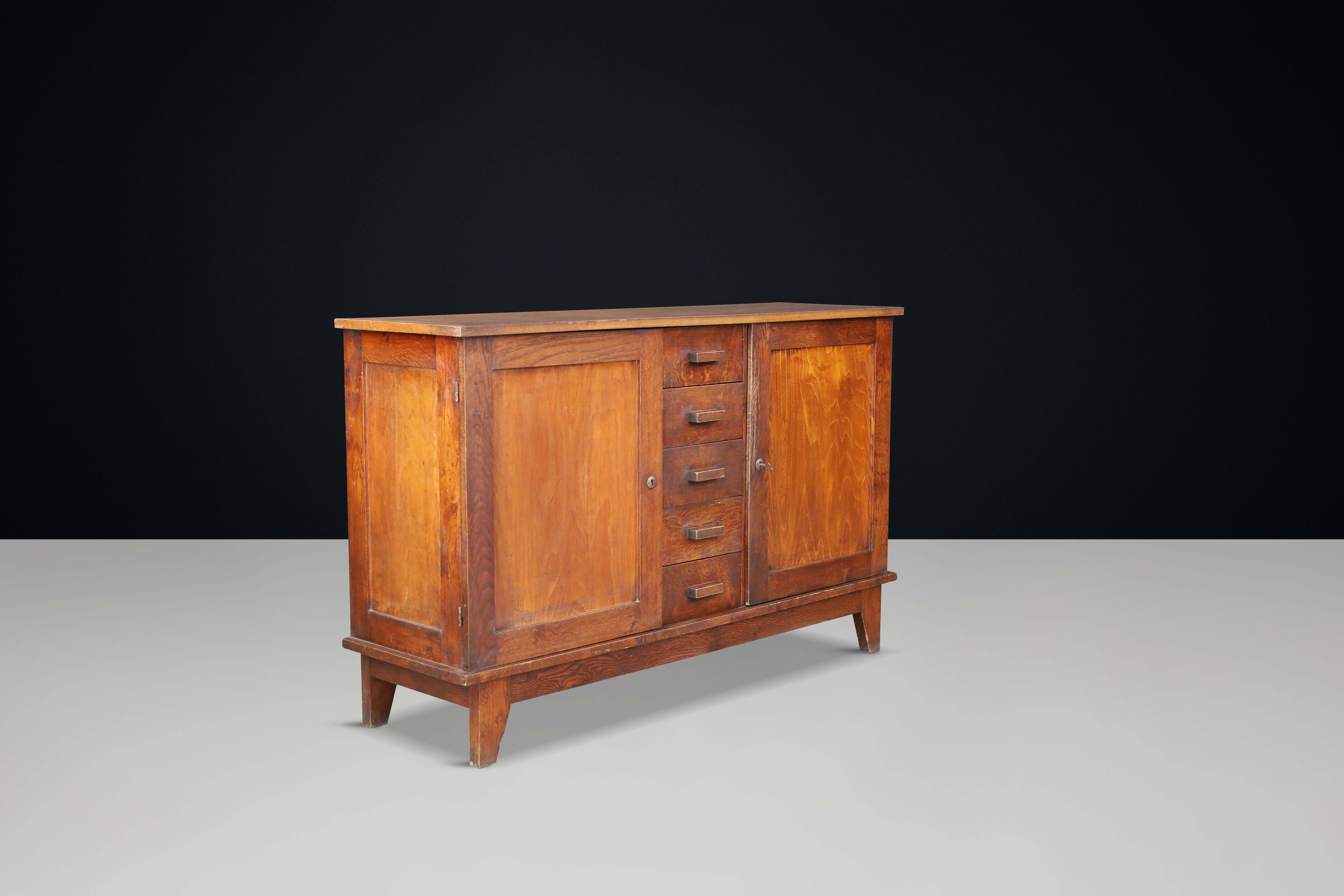 René Gabriel Patinated Oak Sideboard, France, 1940s

This mid-century sideboard, crafted from patinated French oak, was designed by René Gabriel in the 1940s in France. It was part of a collection of emergency furniture created for war victims,