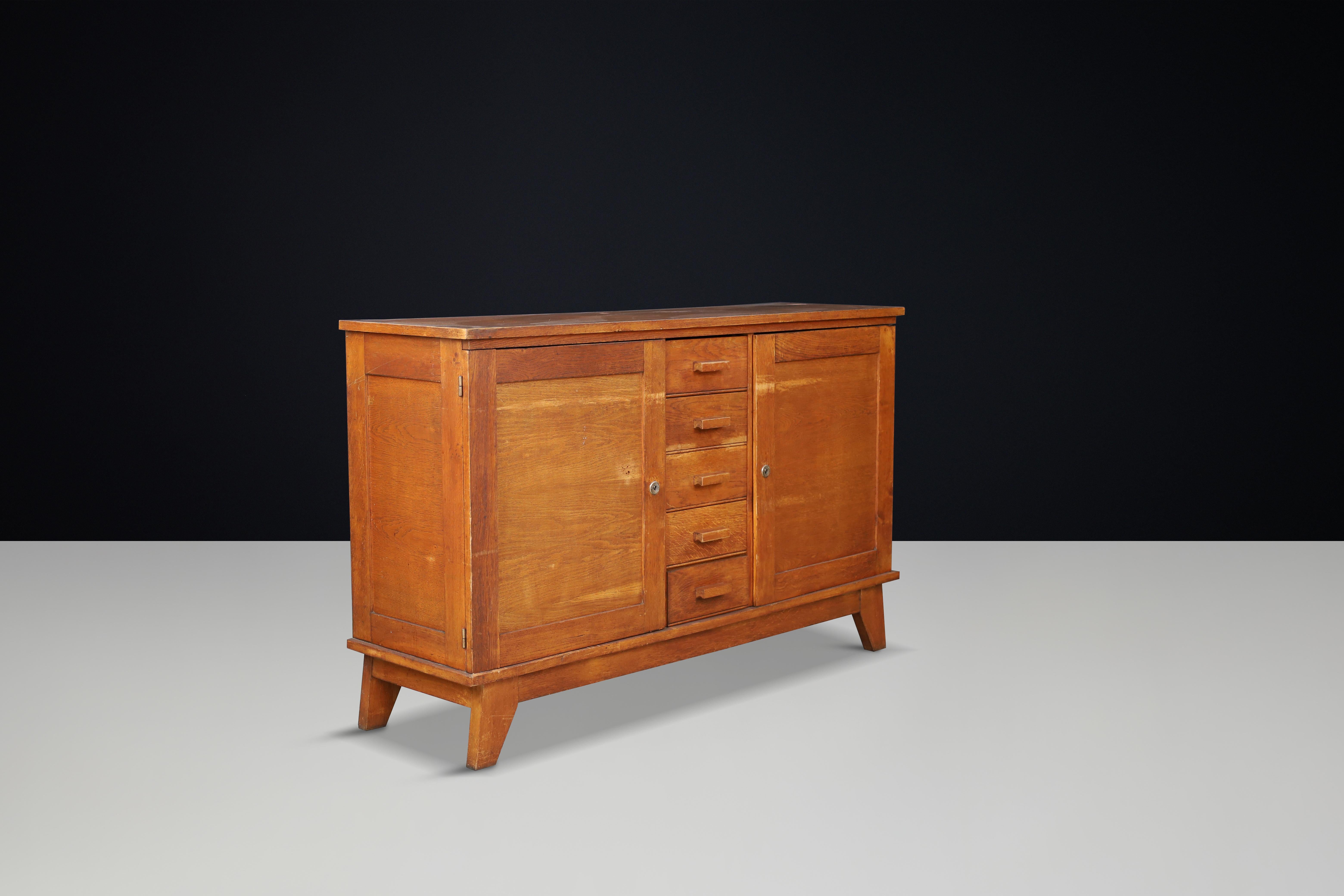René Gabriel Patinated Oak Sideboard, France, 1940s

This mid-century sideboard, crafted from patinated French oak, was designed by René Gabriel in the 1940s in France. It was part of a collection of emergency furniture created for war victims,