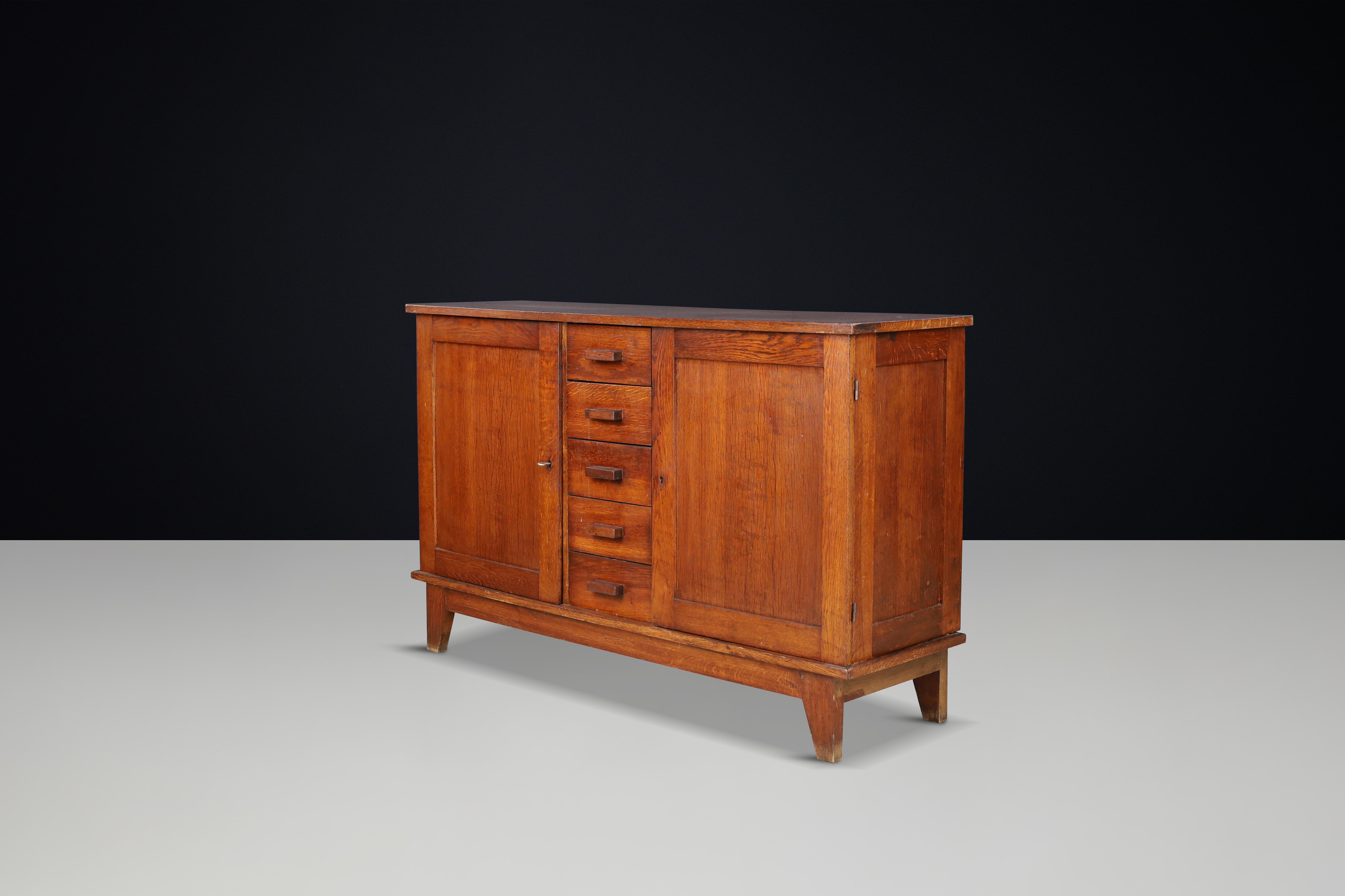 René Gabriel Patinated Oak Sideboard, France, 1940s

This mid-century sideboard, crafted from patinated French oak, was designed by René Gabriel in the 1940s in France. It was part of a collection of emergency furniture created for war victims,