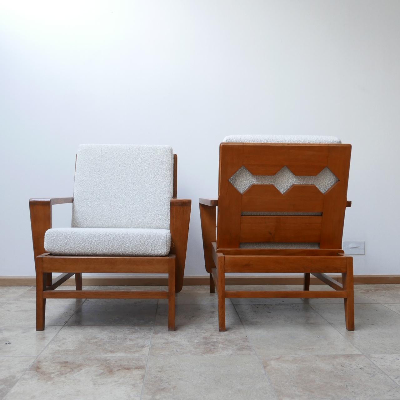 A pair of rare armchairs attributed to René Gabriel.

Re-construction period, circa 1940s, French.

Re-upholstered with an off white boucle fabric.

A scarce model not seen before but with the characteristic kicked out legs.

Dimensions: 74