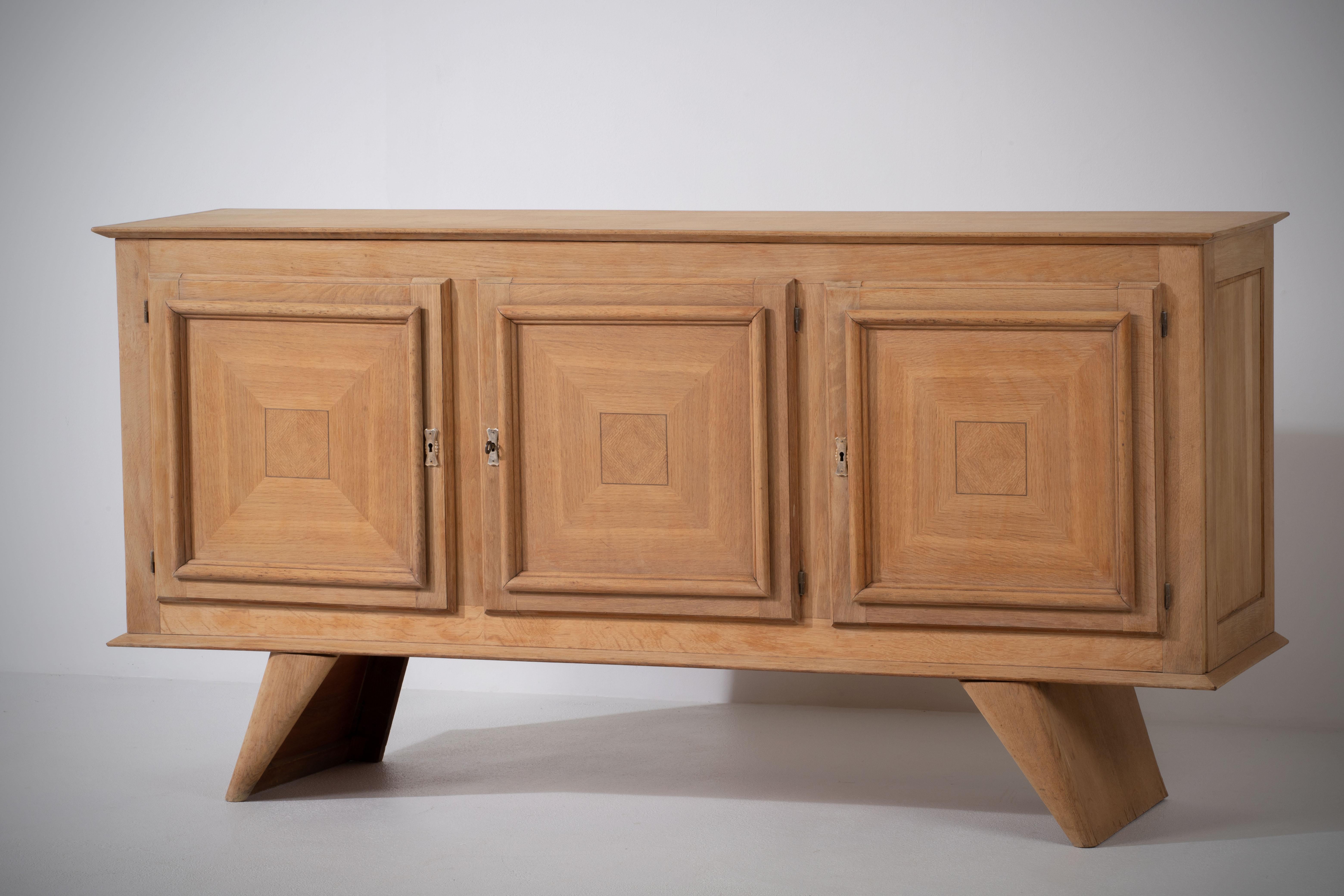 Introducing an extraordinary oak sideboard attributed to the renowned designer René Gabriel. This exceptional piece showcases Gabriel's signature style and attention to detail while highlighting the natural beauty of oak.

Crafted from solid oak,
