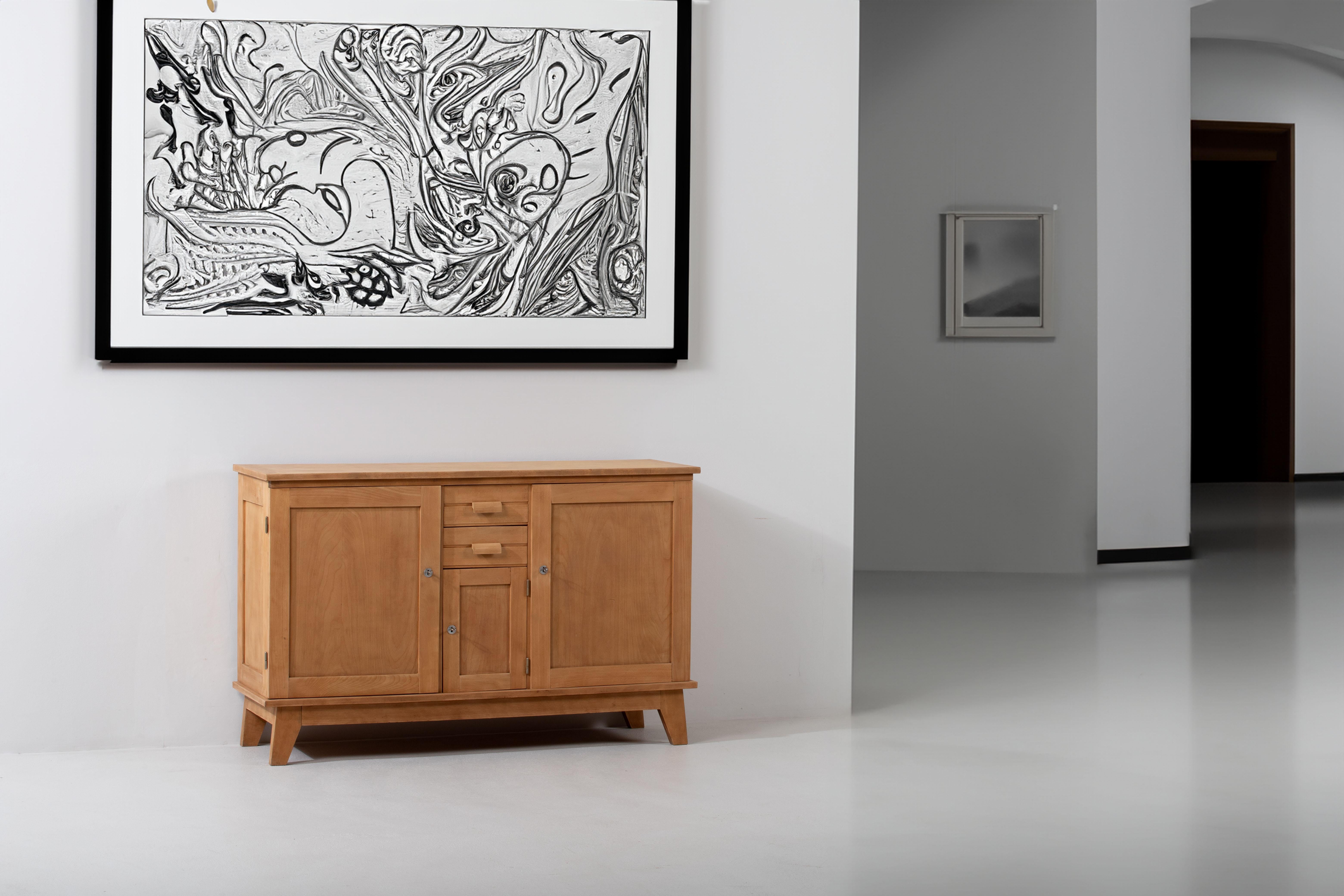 Introducing an extraordinary oak sideboard attributed to the renowned designer René Gabriel. 
This exceptional piece showcases Gabriel's signature style and attention to detail while his presenting the French Reconstruction buffet, meticulously