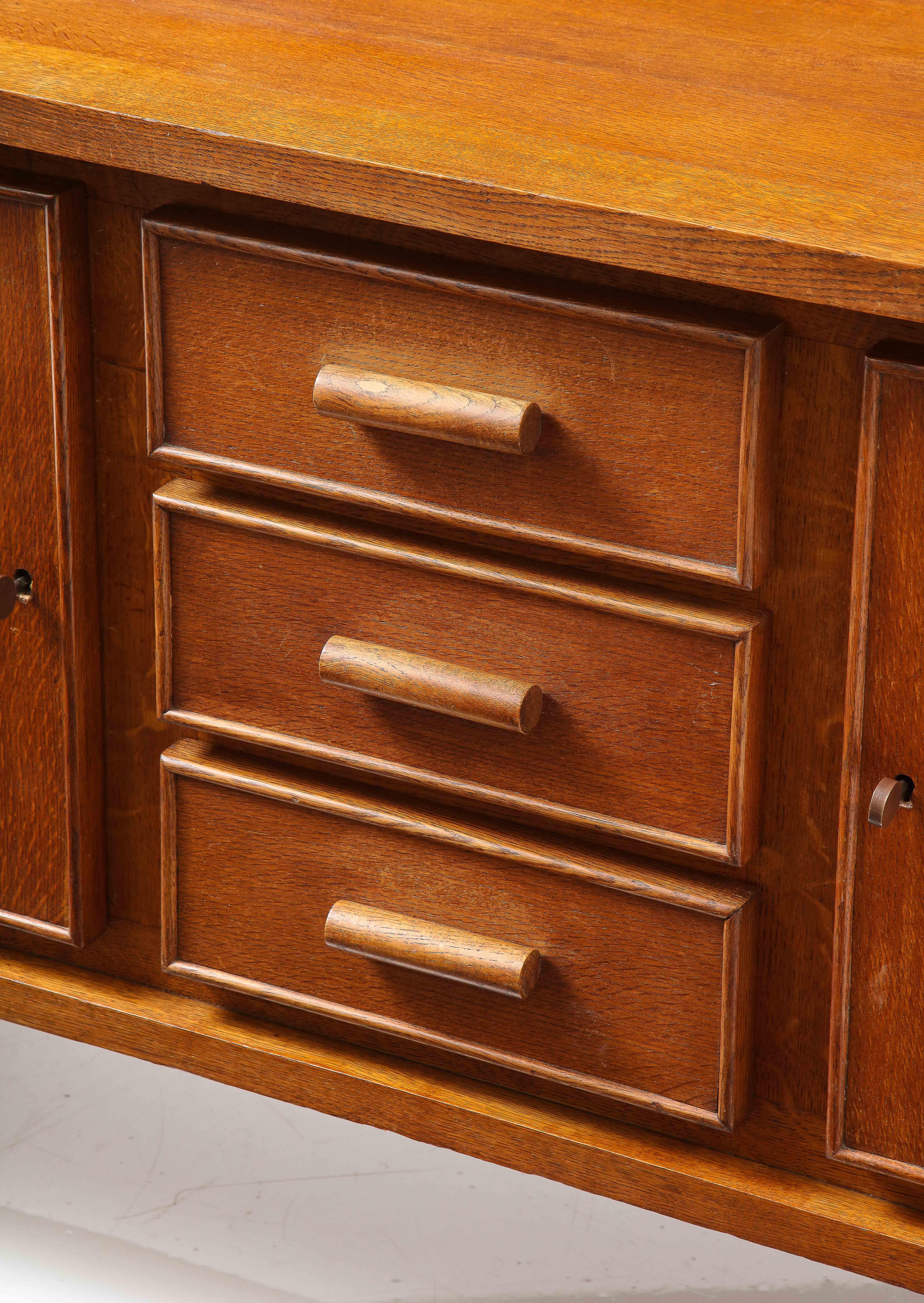 René Gabriel sideboard, rare model 202-150, First edition w wooden handle, France, 1948
Natural oak finish, interiors shelves.
Oak, original keys, wonderful original patina, bead detail & handles.
