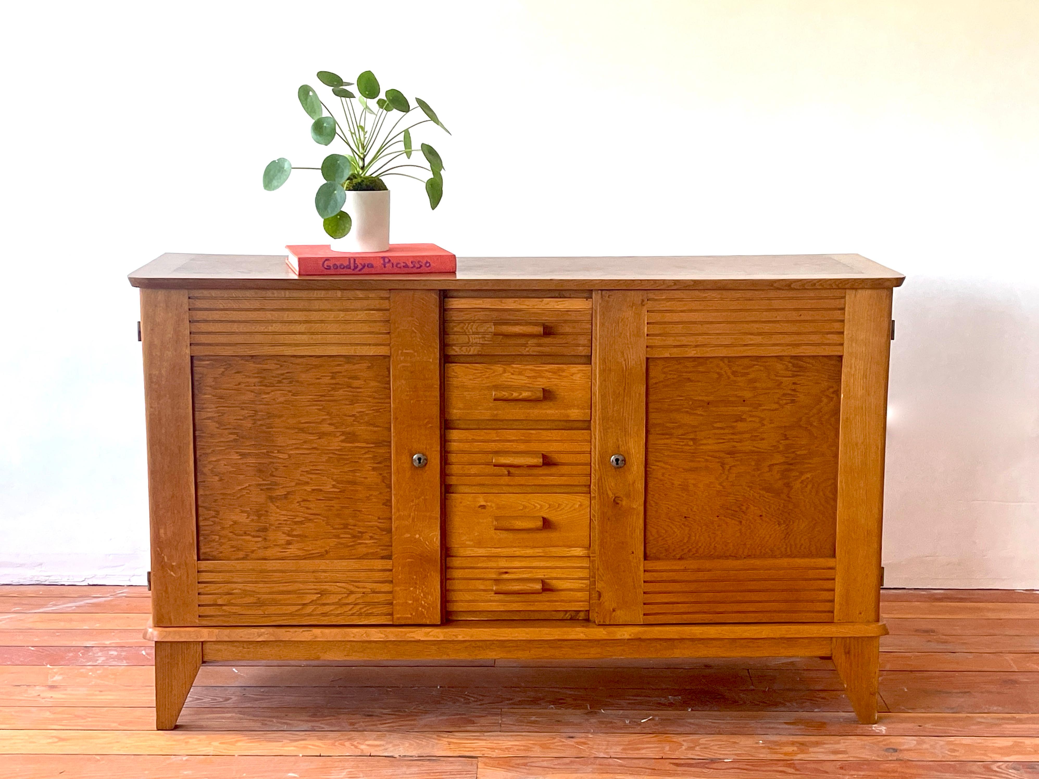 French oak by René Gabriel, France, 1940s
Great original patina with carved horizontal detailing.
 