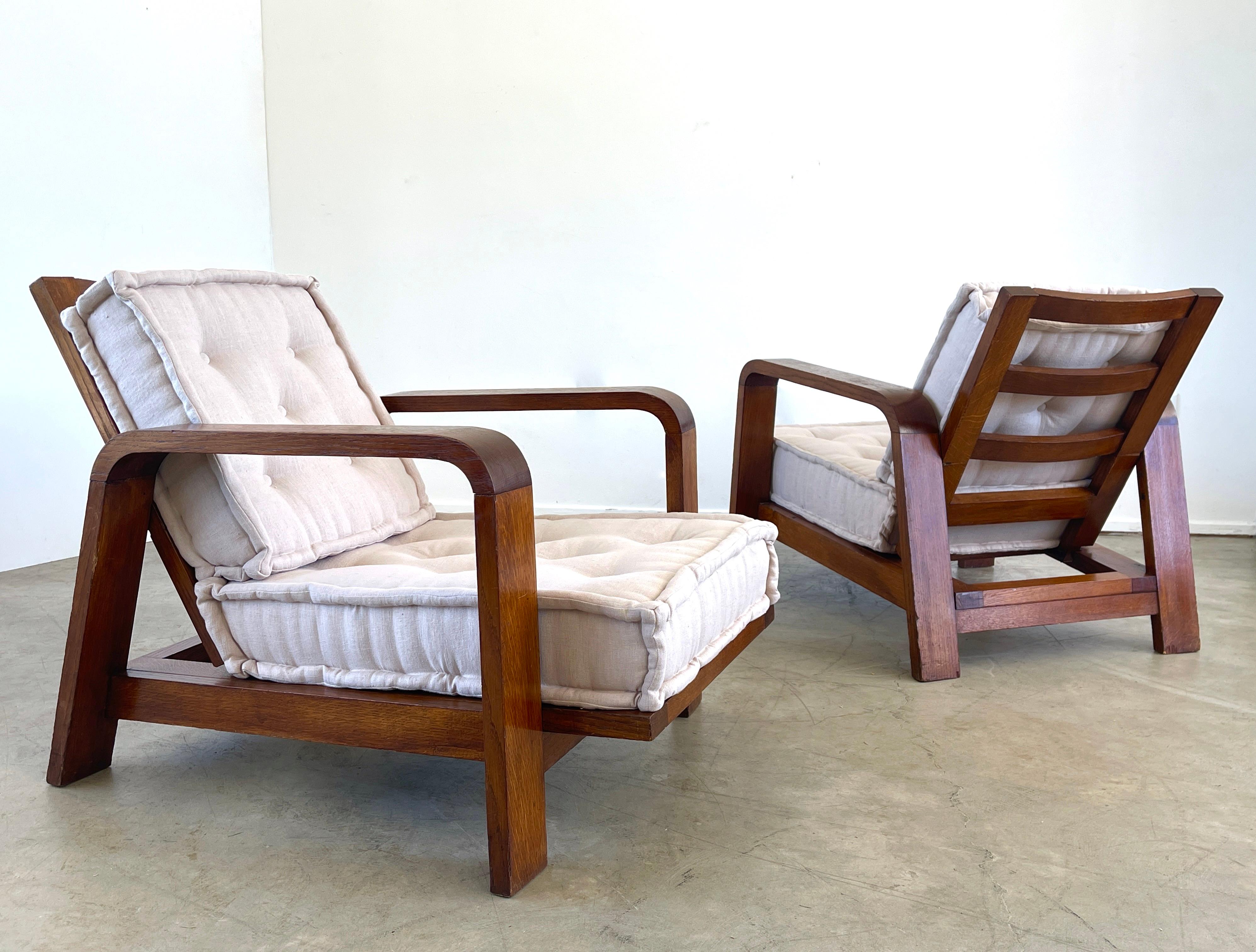 Wonderful pair of French oak chairs attributed to Rene Gabriel
Newly upholstered linen seat cushions with French seams 
Great wood patina and simple lines.