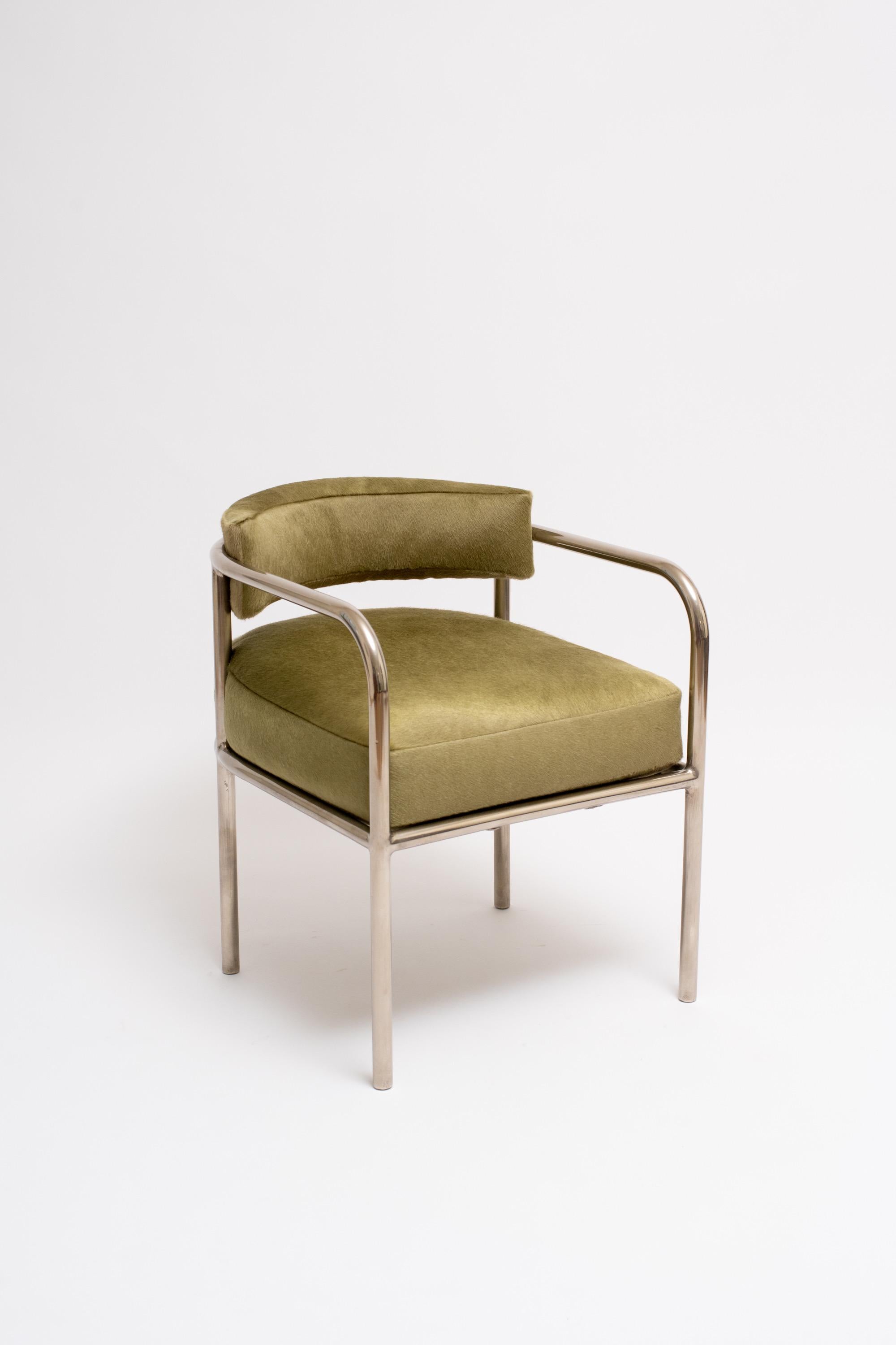 A rare armchair of nickel-plated tubular steel and calfskin cushions by French modernist René Herbst. Herbst was a founding member of the Union des Artistes Modernes, an influential group of progressive designers that included: Eileen Gray, Le