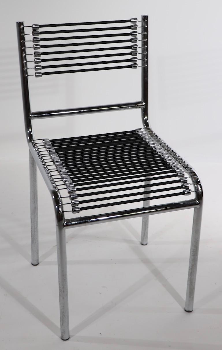 1990's version of iconic Sandows chair designed by René Herbst. The seat and back rest are of black elastic cord, the frame is of bright tubular chrome. This example was made in Italy and is in excellent original condition, clean and ready to use.