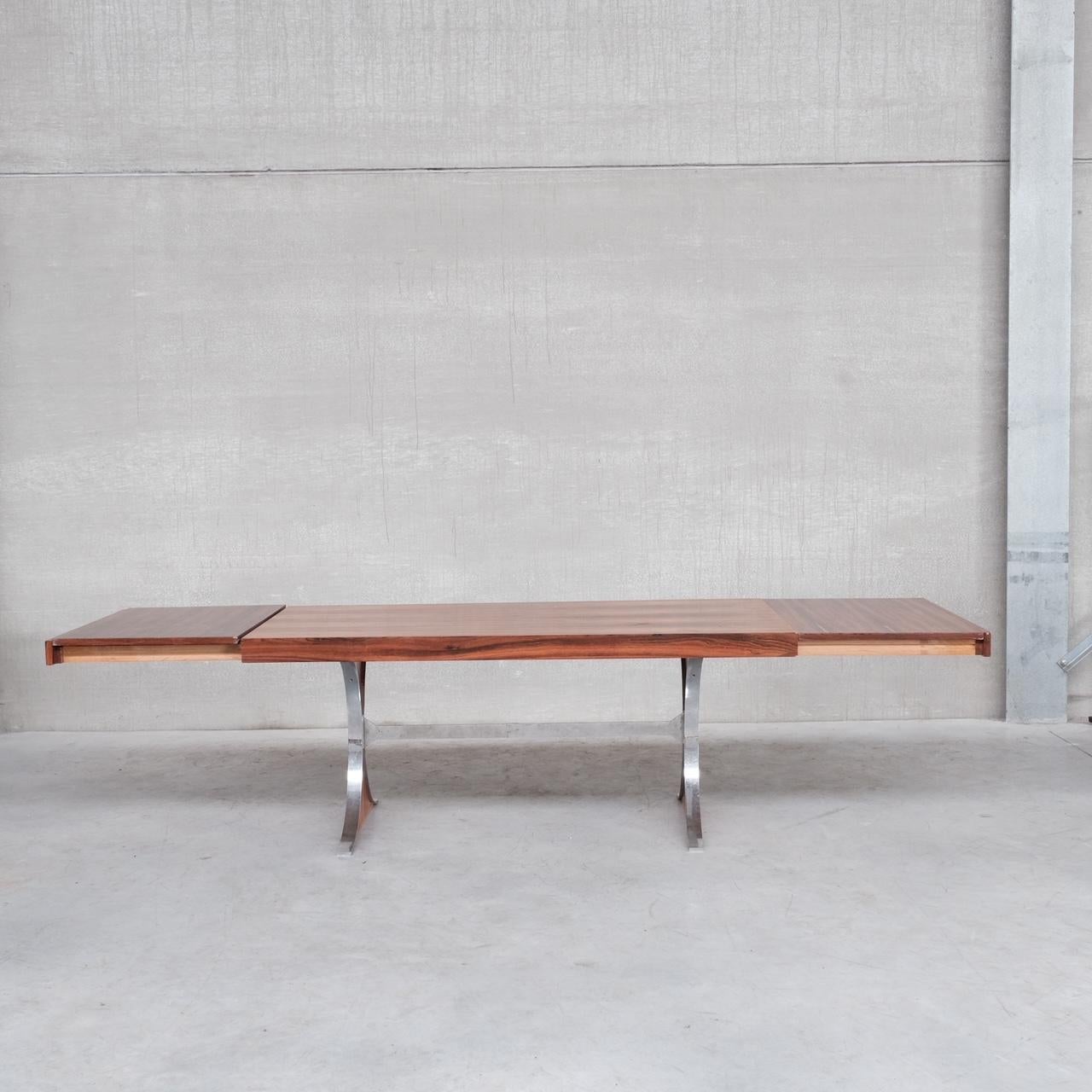A rosewood dining table by René-Jean Caillette. 

France, c1961. 

'Sylvie' model. 

Has optional two additional leaves which add 58 cm each. 

Remains in good vintage condition, some small lifting here and there but no veneer tears. The