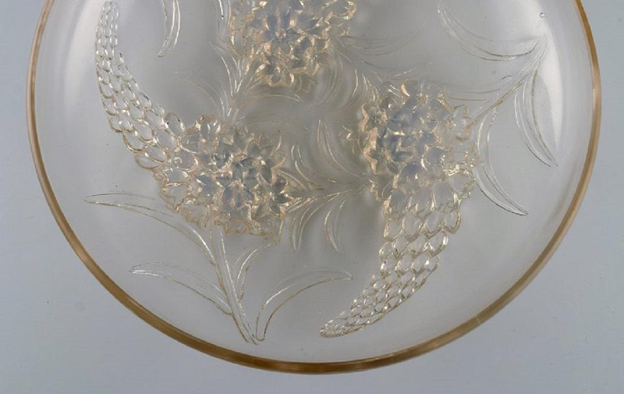 René Lalique (1860-1945), France. 
Early and rare Veronique bowl in frosted mouth-blown art glass with flowers and foliage in relief. 
1920s.
Measures: 22 x 5.8 cm.
In excellent condition.
Stamped: R. Lalique, France.