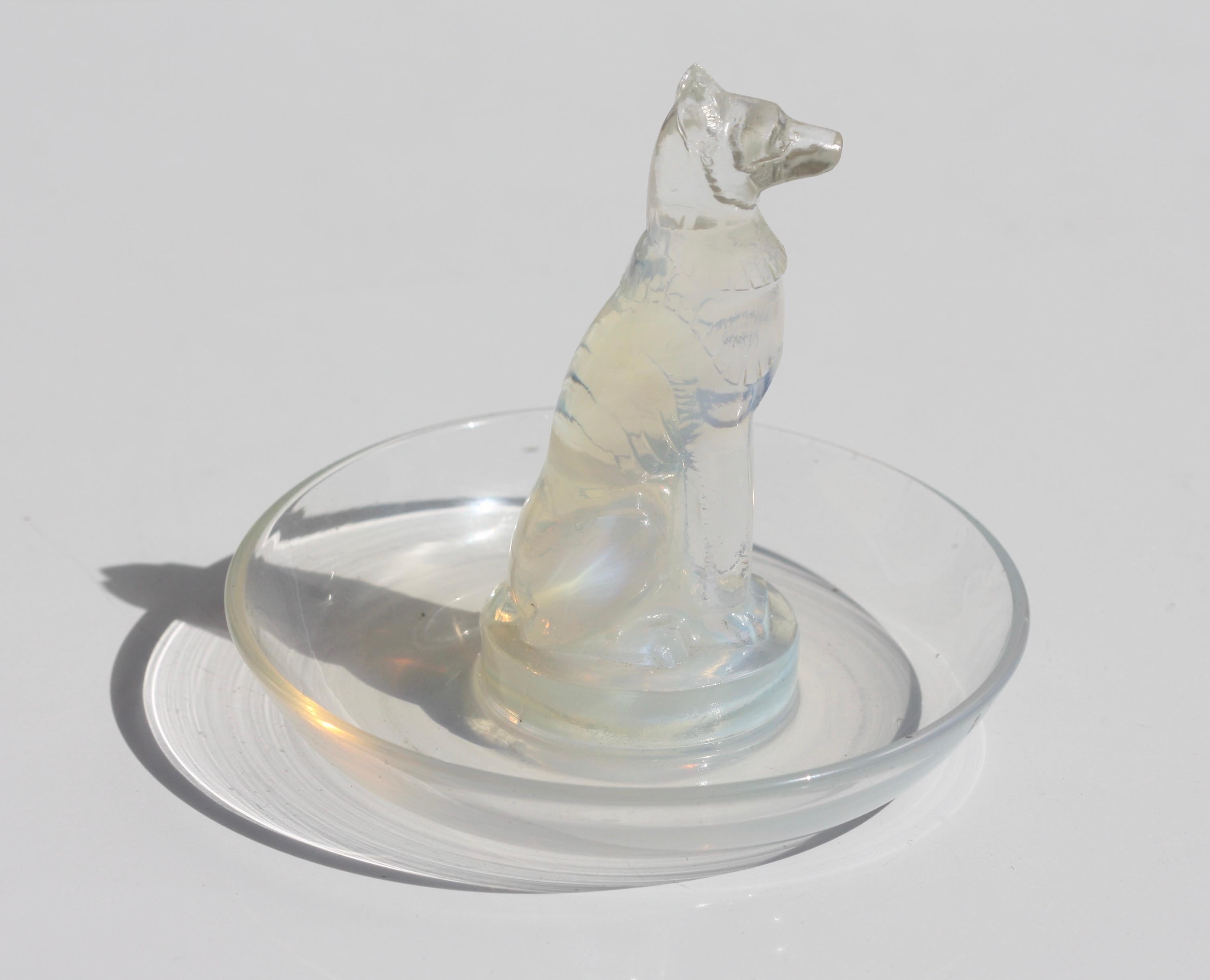 René Lalique (1860-1945)
An opalescent glass cendrier, Marcilhac No. 290, acid stamped R. Lalique
model introduced 1926
3 1/4 in. (8.2 cm) high
3 1/2 in. (8.8 cm) wide.
  